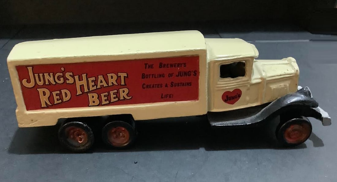 JUNGS RED HEART BEER CAST IRON TRUCK: JUNGS RED HEART BEER CAST IRON TRUCK MEASURES APPROX 8 INCHES LONG2.5 INCHES HIGH. MIGHT NEED SOME TIGHTENING ON SCREW BOTTOM