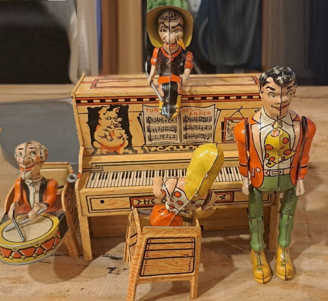 Lil Abner tin lith windup toy works!: Lil Abner and his dog patch tin lith windup toy works! 1945. The Piano is 9" wide This is Lil Abner's Dog Patch Band. It works great, Daisy Mae is at the piano,Mammy Yocum keeps time, Pappy Yocum play