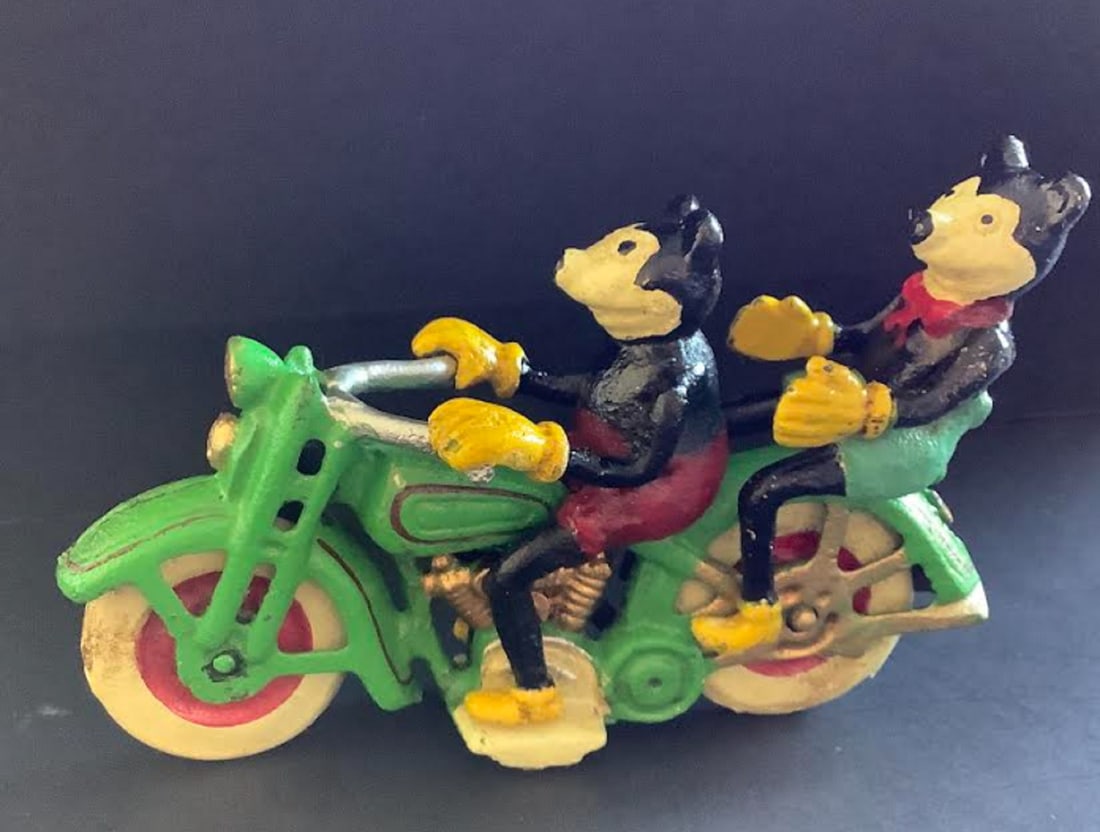 DISNEY CAST IRON Mickey And Minnie Mouse On Motorcycle: Mickey Mouse on motor bike figure. Cast iron. Bike painted Red / Green with White wheels. The bike wheels turn. Measures approx. 10cm tall, 7cm wide, by 16cm deep. Total Weight - 787g.
