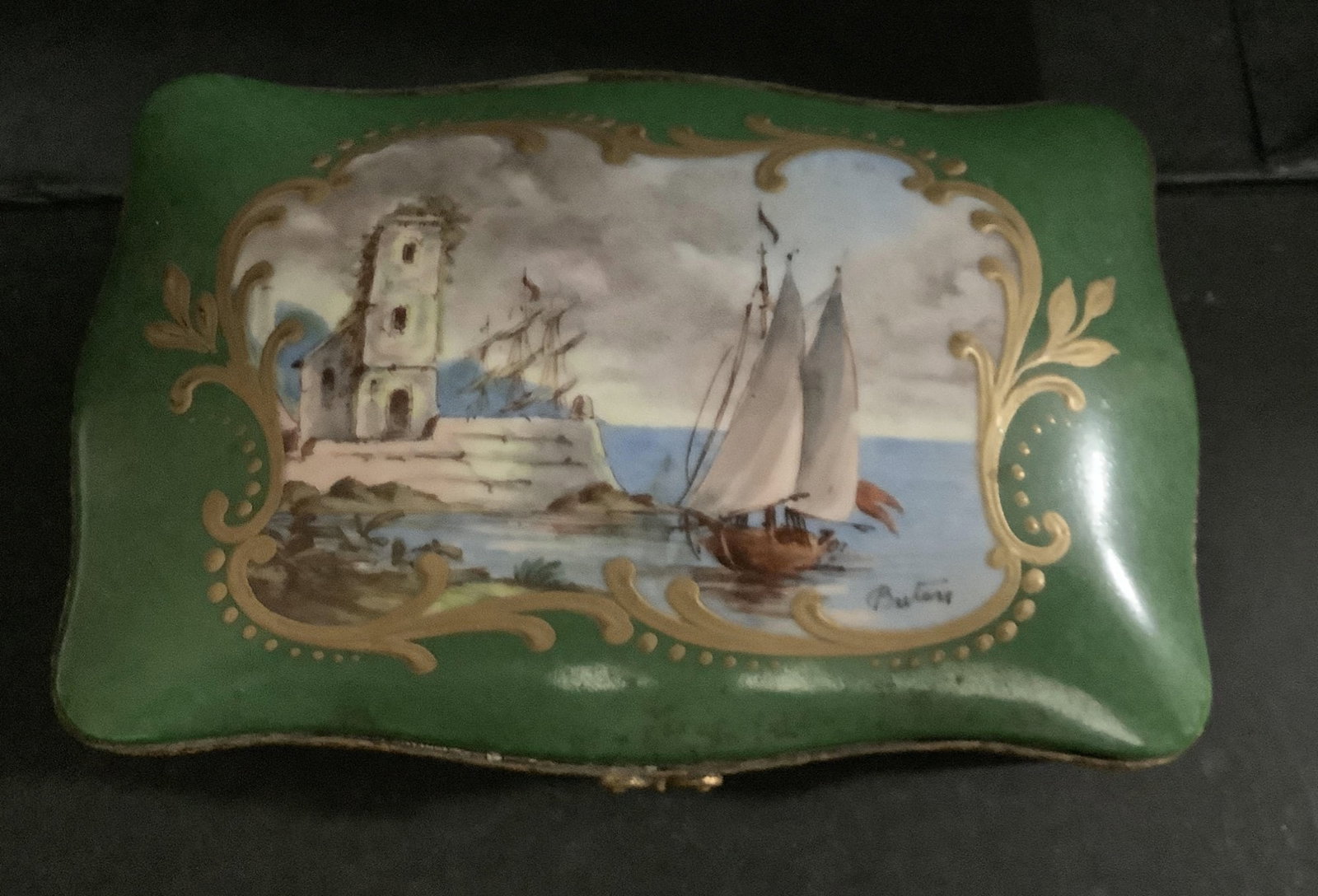 antique French Sevres porcelain jewel box bonbonniÃ¨re, in dark royal green color and with ornate: antique French Sevres porcelain jewel box bonbonniÃ¨re, in dark royal green color and with ornate gilt decorative motif, further embellished with a hand painted maritime motif on lid cover. This ant