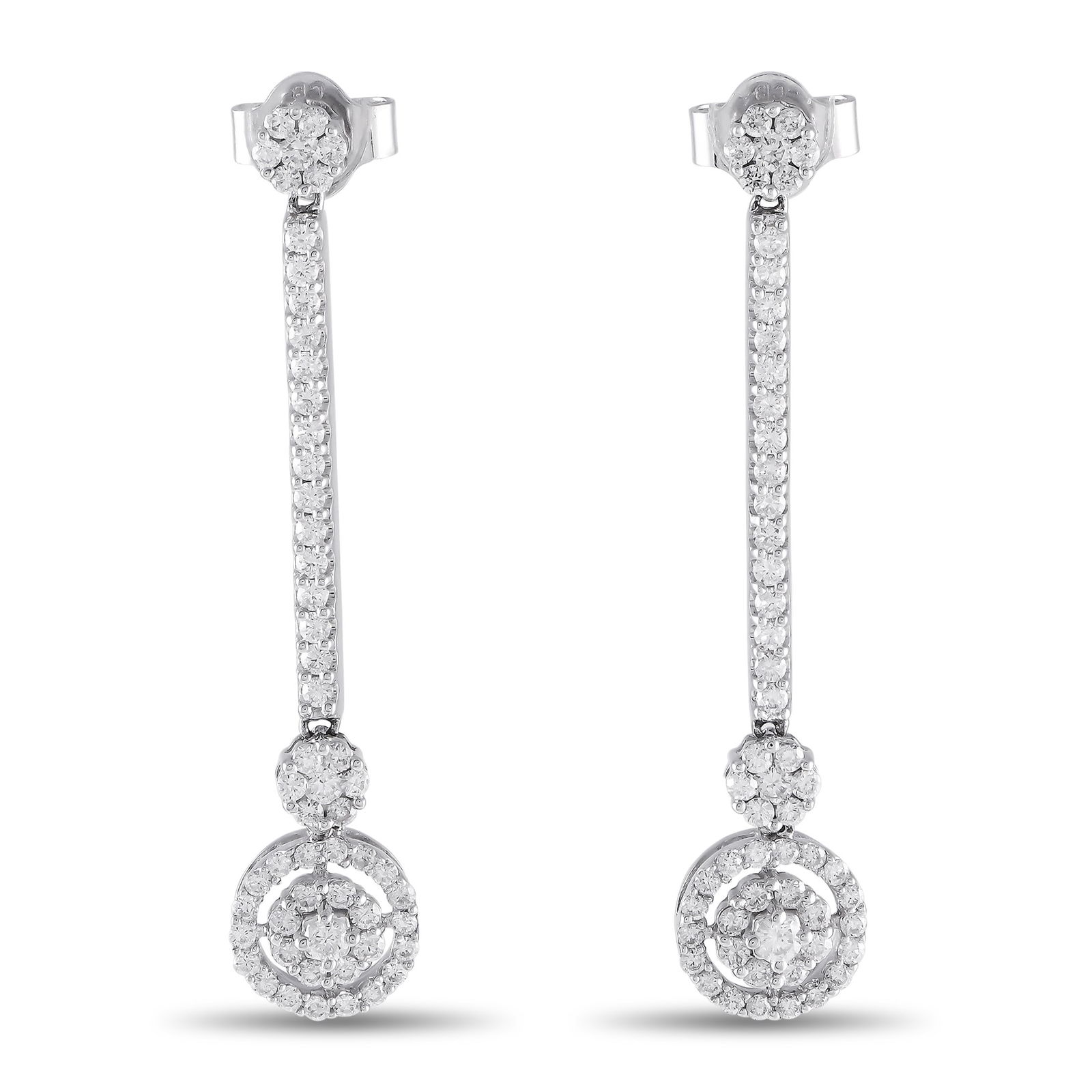 Bucherer 18K White Gold 1.34ct Diamond Dangle Earrings: These white gold sparklers exude an undeniable aura of class and refinement. Made by Bucherer, these drop earrings feature a diamond cluster post secured by a push-back clasp. A vertical line of diamo