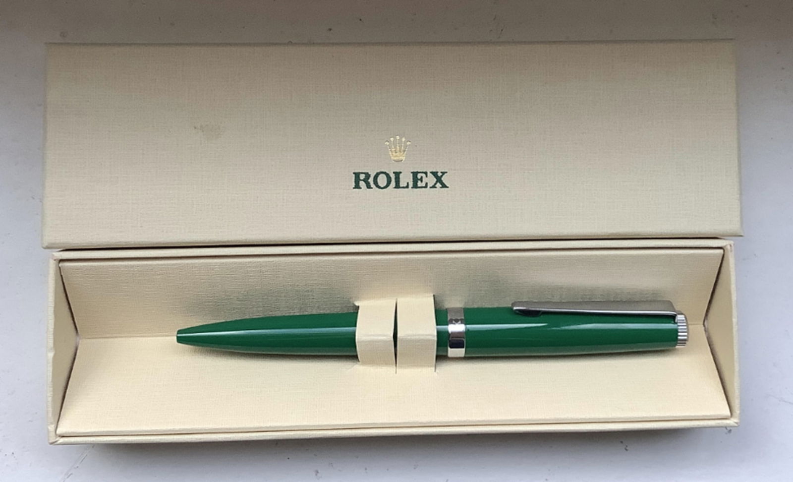 Rolex Green Emerald Emblem Twist Ballpoint Pen With Box: Rolex Green Emerald Emblem Twist Ballpoint Pen With Box. Elevate your writing to luxurious new heights with this distinguished Rolex Green Ballpoint Pen. this pen is a mark of distinction and a rare c