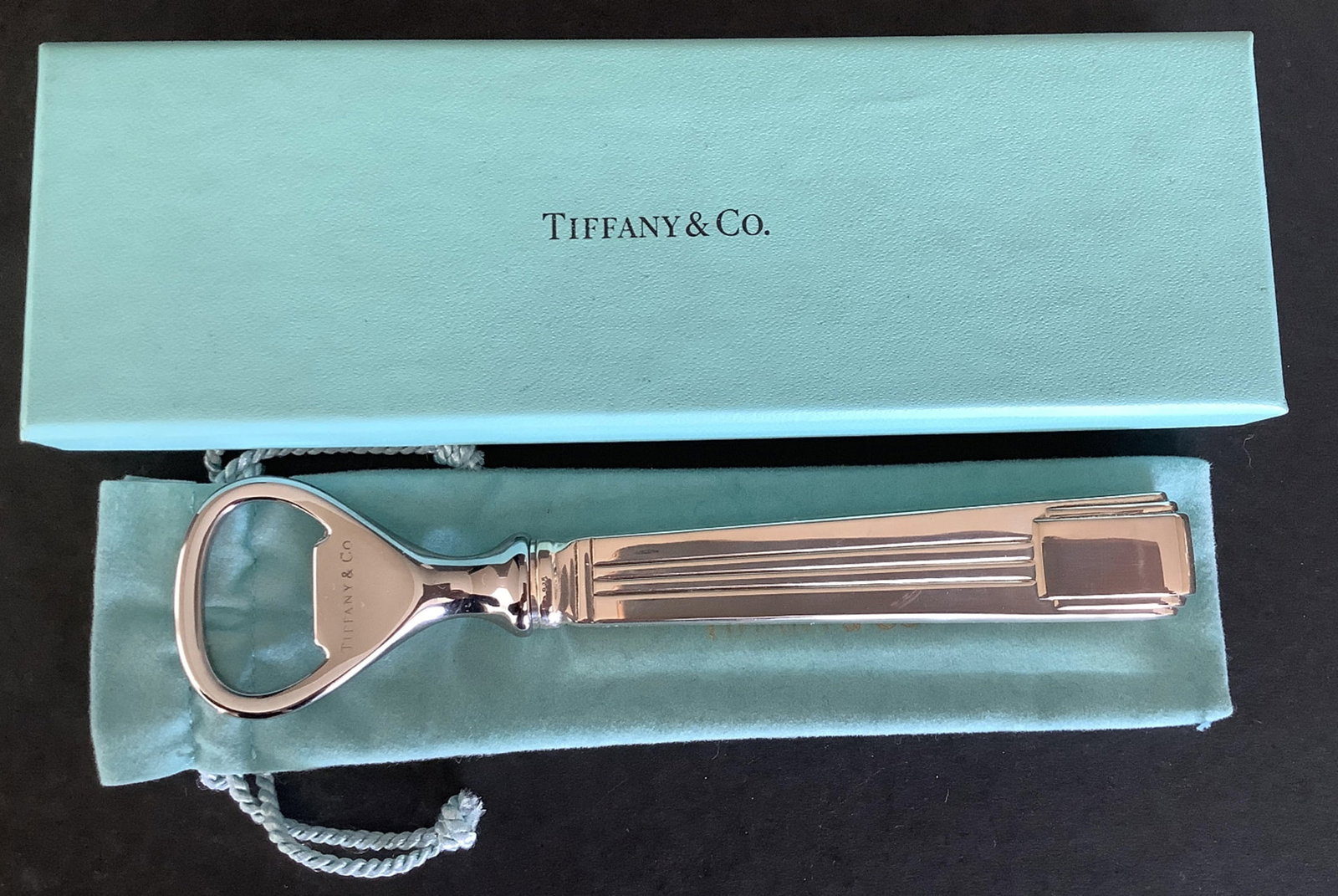 Tiffany & Co Sterling Silver Century Pattern Bottle Opener With Orig Box: Tiffany & Co Sterling Silver Century Pattern Bottle Opener With Orig Box With Pouch. The piece is in excellent estate condition and ready to use. It is not monogrammed or engraved. It is signed "Tiffa