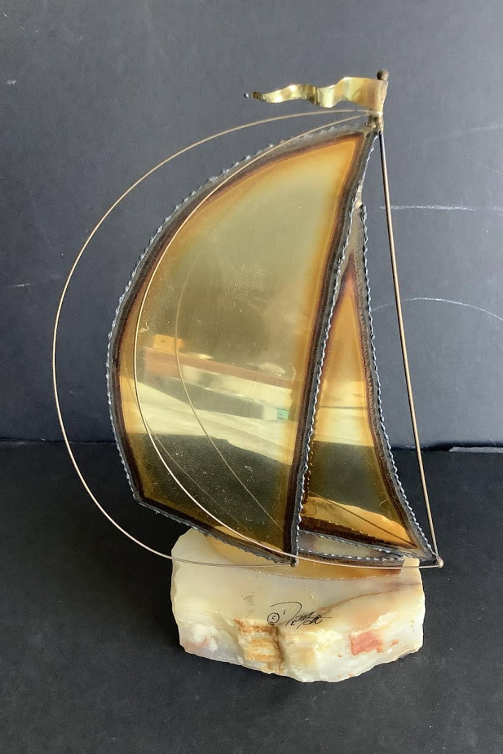 MCM SIGNED BRASS BOAT ON MARBLE BASE: MCM SIGNED BRASS BOAT ON MARBLE BASE measures approx 9 inches tall5 3/4 inches wide