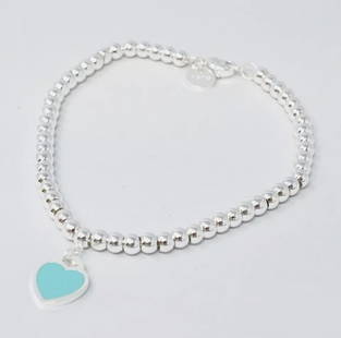 Tiffany & Co. Sterling Silver Blue Enamel Heart Bracelet And Box: Tiffany & Co. Sterling Silver Blue Enamel Heart Bracelet And Box. Tiffany & Co Pink Heart Tag Beaded Bracelet in Silver, 4 mmLike-new condition, no signs of wear, see photosSize medium,7 inches Fits