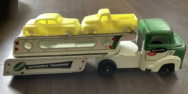Wyandotte Tin Auto Transporter Truck With Vehicles: Wyandotte Tin Auto Transporter Truck With Vehicles. The truck and trailer are about 12 1/2" long. The cars are about 3 1/2" long.