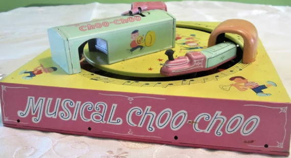 Marx Tin Litho Wind Up Train Set with Box  Made in Japan 1966: Marx Tin Litho Wind Up in Box Made in Japan 1966. Marx wind up toy. A tin litho train that goes around its track playing music. There's a pink key on the top that is wound up and then an "on off" swit