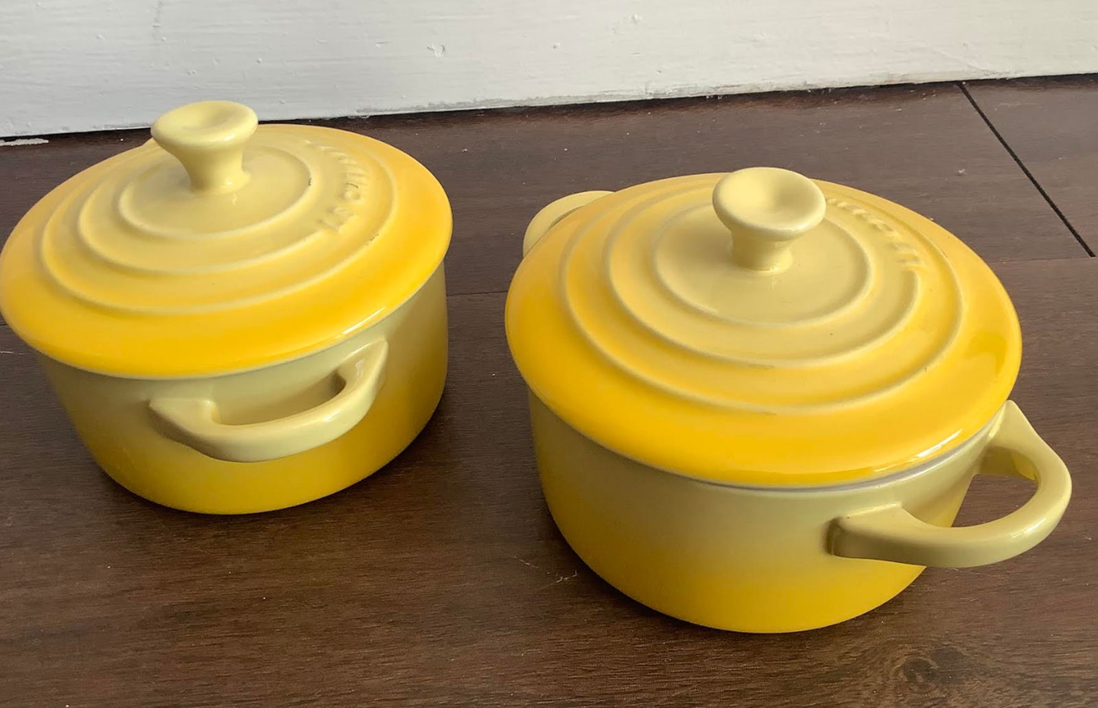 Le Crueset Yellow Mini Pot pair Set of 2 Stoneware: Le crueset Mini Pot set of 2. measures approx Interior: 3.5" L x 3.5" W x 1.7" H. Exterior: 5.4" L x 4.2" W.3.5 inches at tallest part great condition