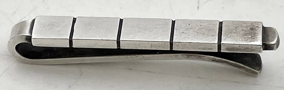 Georg Jensen Sterling Silver Tie Pin #64B: Georg Jensen sterling silver tie pin, in pattern number 64B, with an elegant, geometric design. It measures 1 1/2'' in length by 1/8'' in width by 1/3'' and bears hallmarks as shown.Danish silversmith