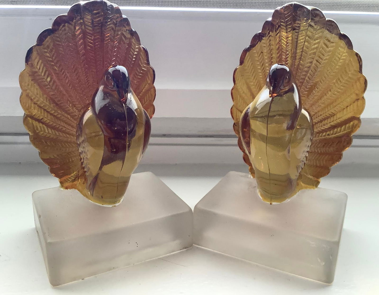 Indian Amber Figurine Bookend Pair: Indian Amber Figurine Bookend Pair. Measures approx 5 3/4 inches tall and3.5 inches wide