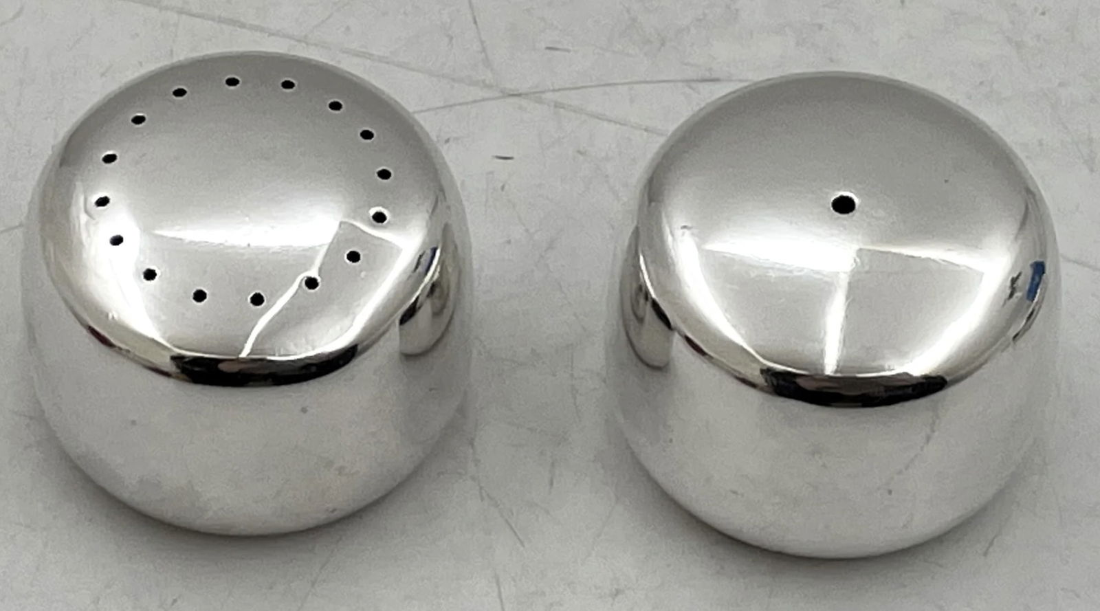 Georg Jensen Sterling Silver Salt and Pepper Shakers: Georg Jensen Sterling Silver Salt and Pepper Shakers. Georg Jensen pair of sterling silver salt and pepper shakers, designed by Henning Koppel in pattern number 1135, and in Mid-Century Modern style w