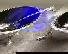 CARTIER STERLING SILVER LEAF TRINKET DISH BOWL AND ORIGINAL POUCH: CARTIER STERLING SILVER & COBALT FOOTED OPEN SALT CELLAR WITH SPOON AND ORIGINAL POUCH. Measures approx 2-1/4” ACROSS AND 1-1-4” TALL Great Condtion