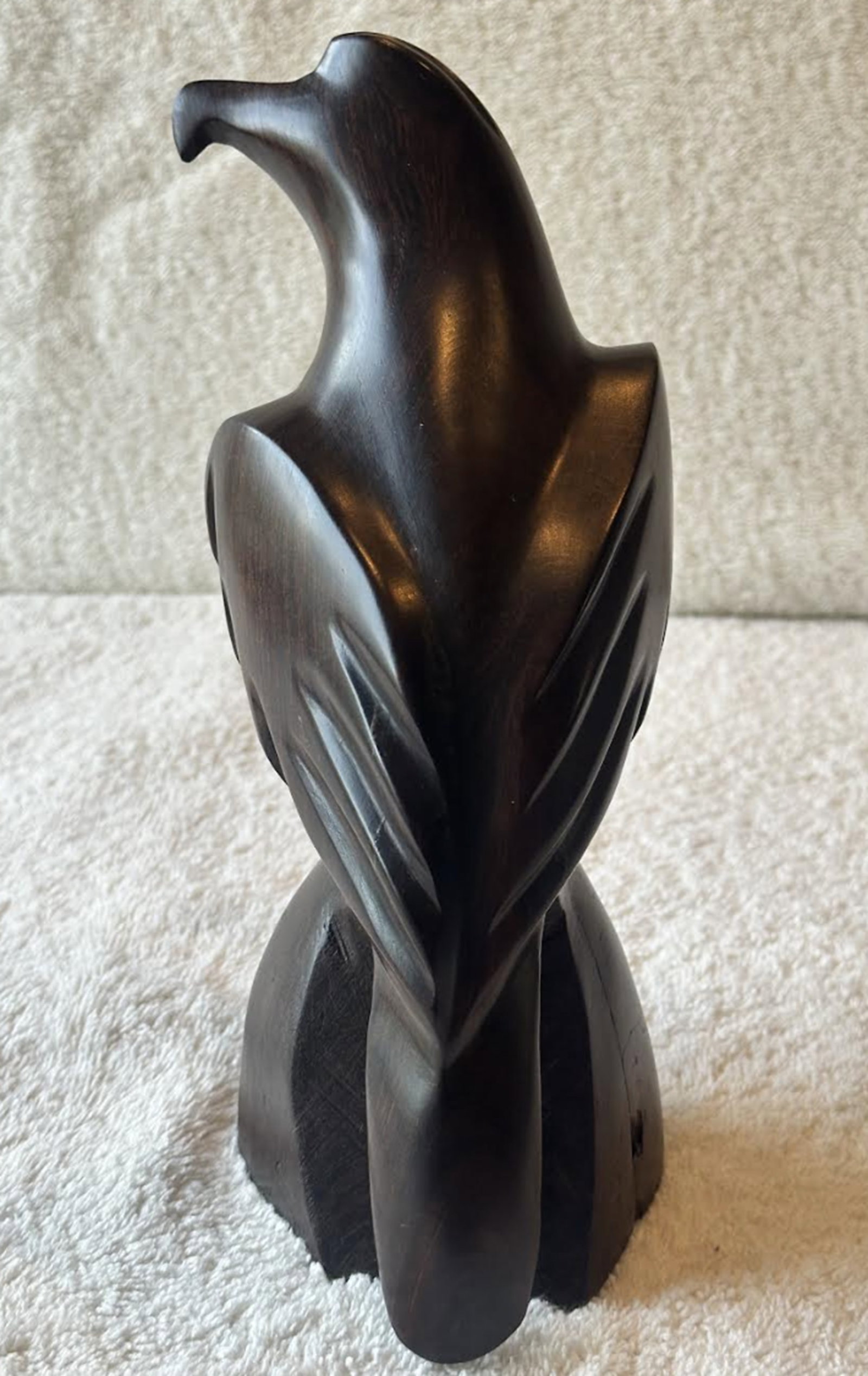 Hand Carved Ironwood Hawk Circa 1980: Hand Carved Ironwood Hawk Circa 1980. The ironwood hawk embodies the grace and power of a bird of prey at rest. Its sleek , flowing lines reveal new dimensions from every angle, while the deep grain a