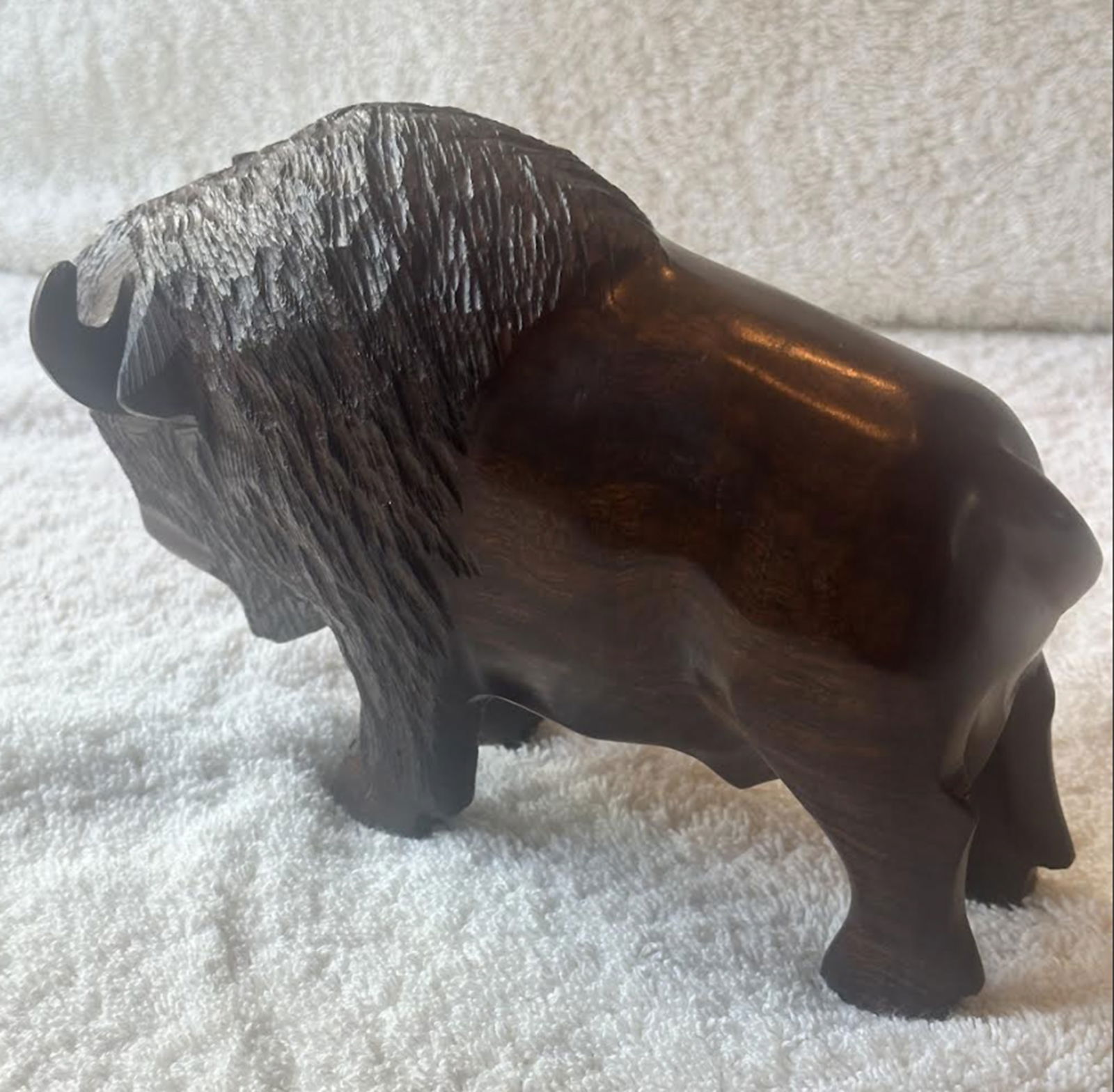 Hand Carved Bison Circa 1978: Hand Carved Bison Circa 1978. The ironwood shows deep chocolate and amber grain patterns that highlight the piece’s organic beauty.Condition: Excellent. No imperfections, no cracks, no chipsMeasures