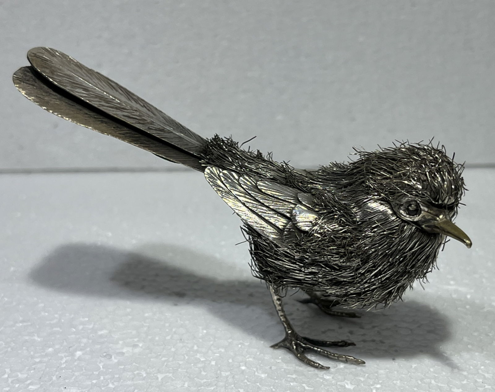 MARIO BUCCELLATI STERLING SILVER BIRD FIGURINE MADE IN ITALY: MARIO BUCCELLATI STERLING SILVER BIRD FIGURINE - sterling silver bird Figurine made by Mario Buccellati using his well-known furry technique High: Measures approx 5 cm, Long: 10 cm. Made in Italy