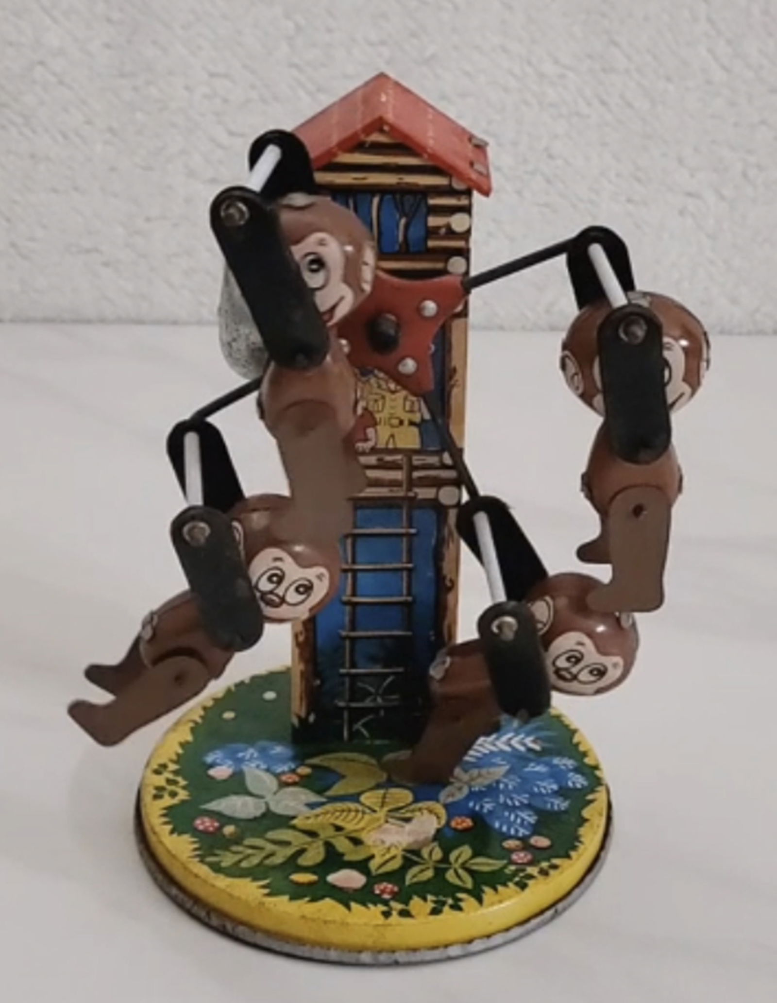 Yonezawa Tin Litho Wind Up Monkey Carousel Made in Japan Works: Yonezawa Tin Litho Wind Up Monkey Carousel Made in Japan Works. The tin toy measures approximately 6 1/2" tall and 4 1/4" wide.
