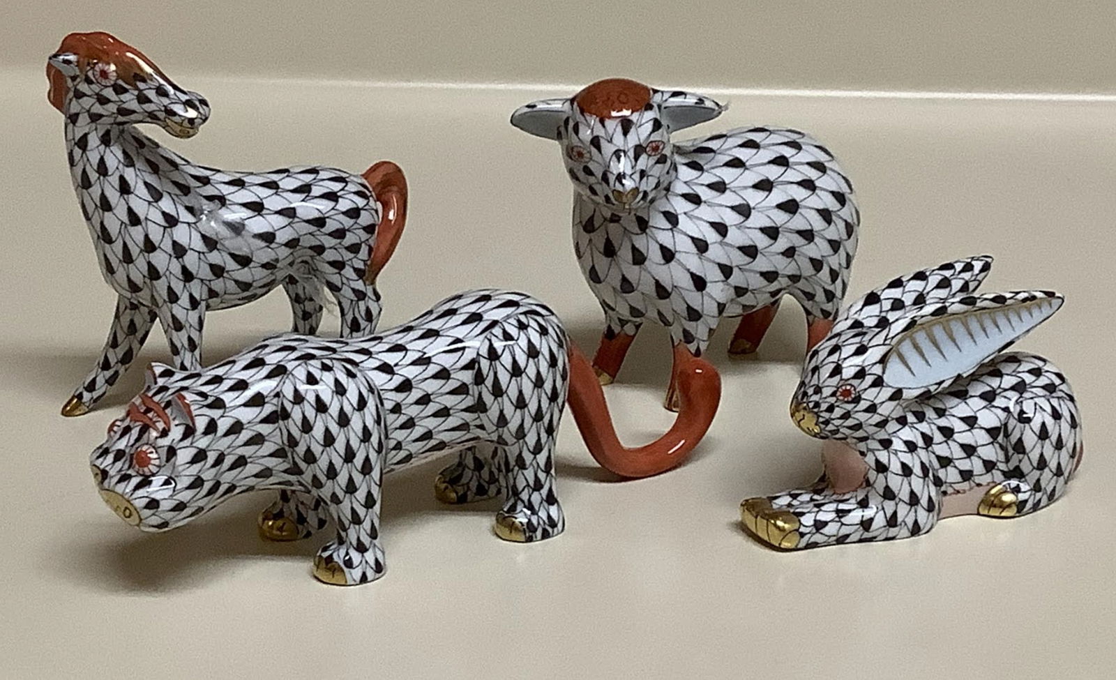 Herend signed d porcelain black and rust fishnet figurines with 24k gold accents: Herend signed d porcelain black and rust fishnet figurines with 24k gold accents. Tiger: 4.5 inches long by 1 3/4 inches tall Horse: 2 3/4 long by 3 inches tall GOAT: 2 3/4 long by 2.5 tall Bunny rabb