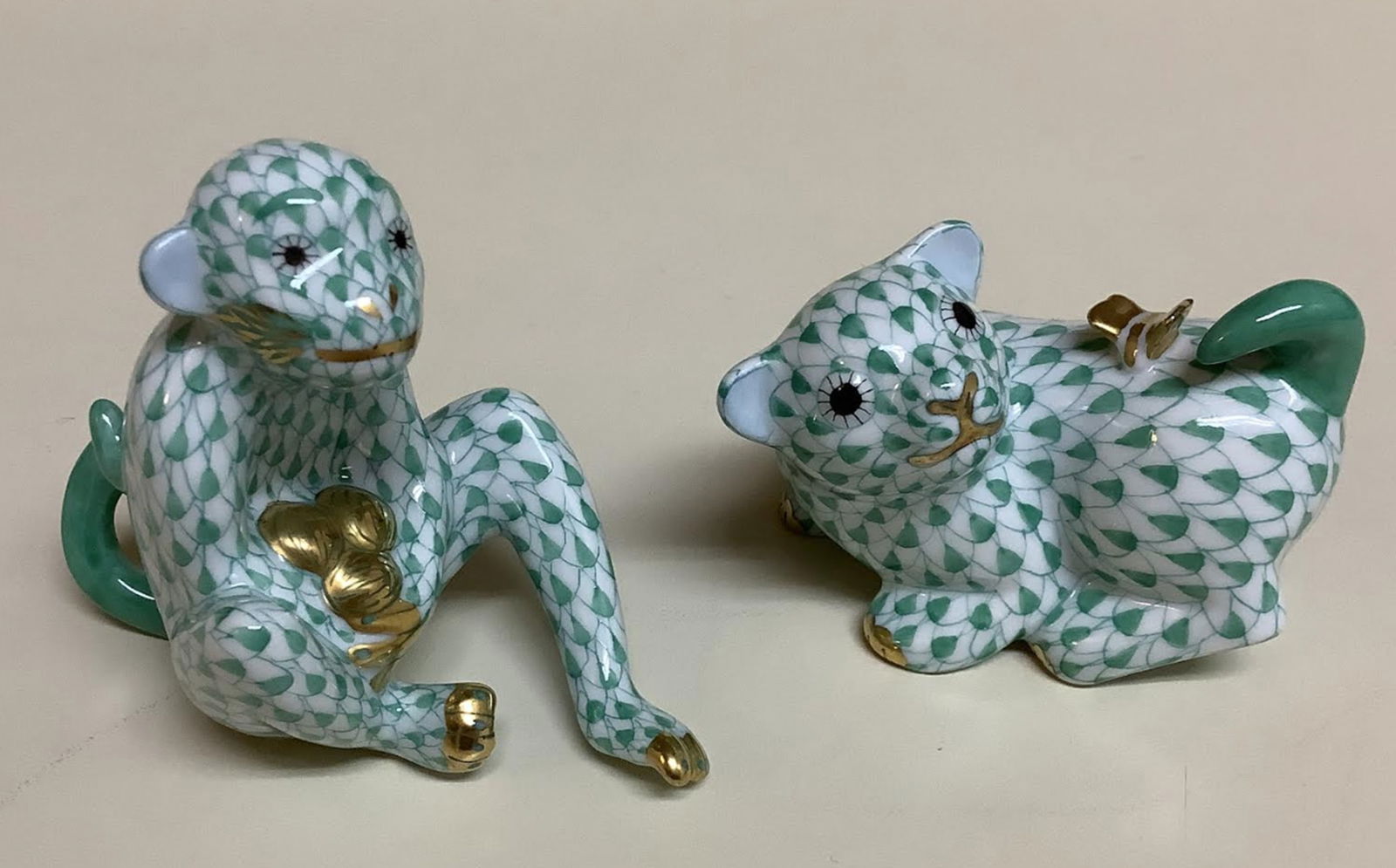 Herend signed porcelain green fishnet figurine with 24k gold accents: Herend signed porcelain green fishnet figurine with 24k gold accents. Monkey: 3 inches long by 2 3/4 tall Pup: 2.5 inches long by 2 inches tall