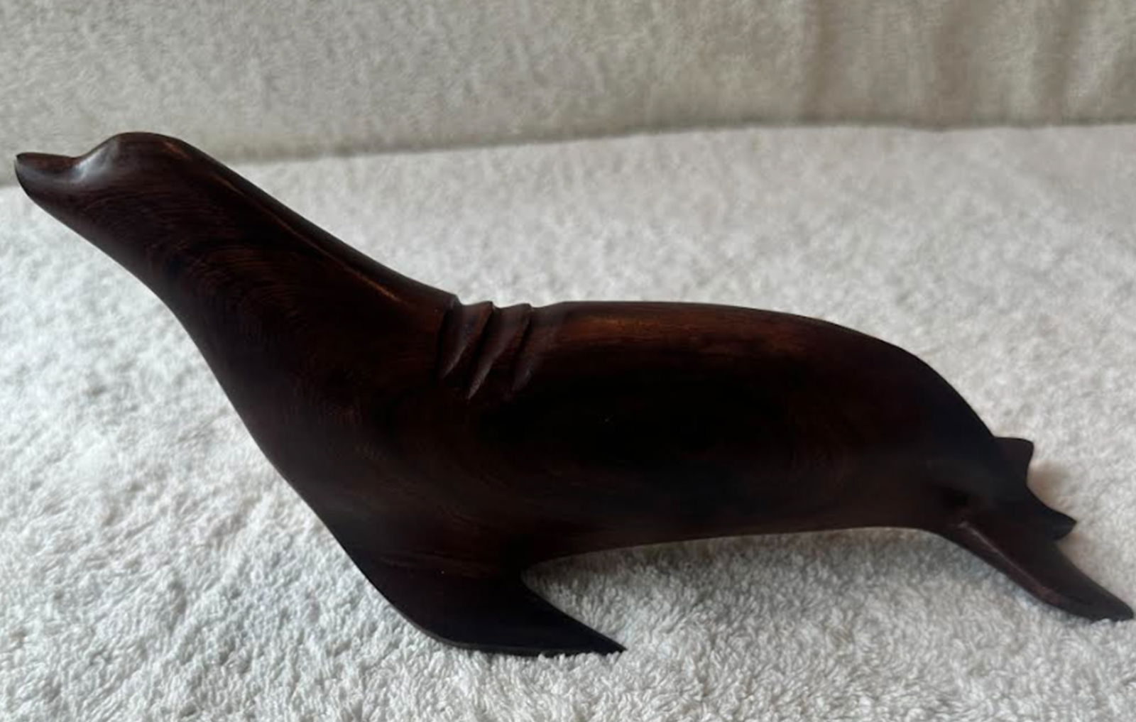 Hand Carved Ironwood Sea Lion Figurine Statuette Circa 1980: sea lion hand carved from solid, dense ironwood. This piece favors restraint over excess detail or weight with clean lines and a balanced, upright form. It expresses the artists’ skill and the natur