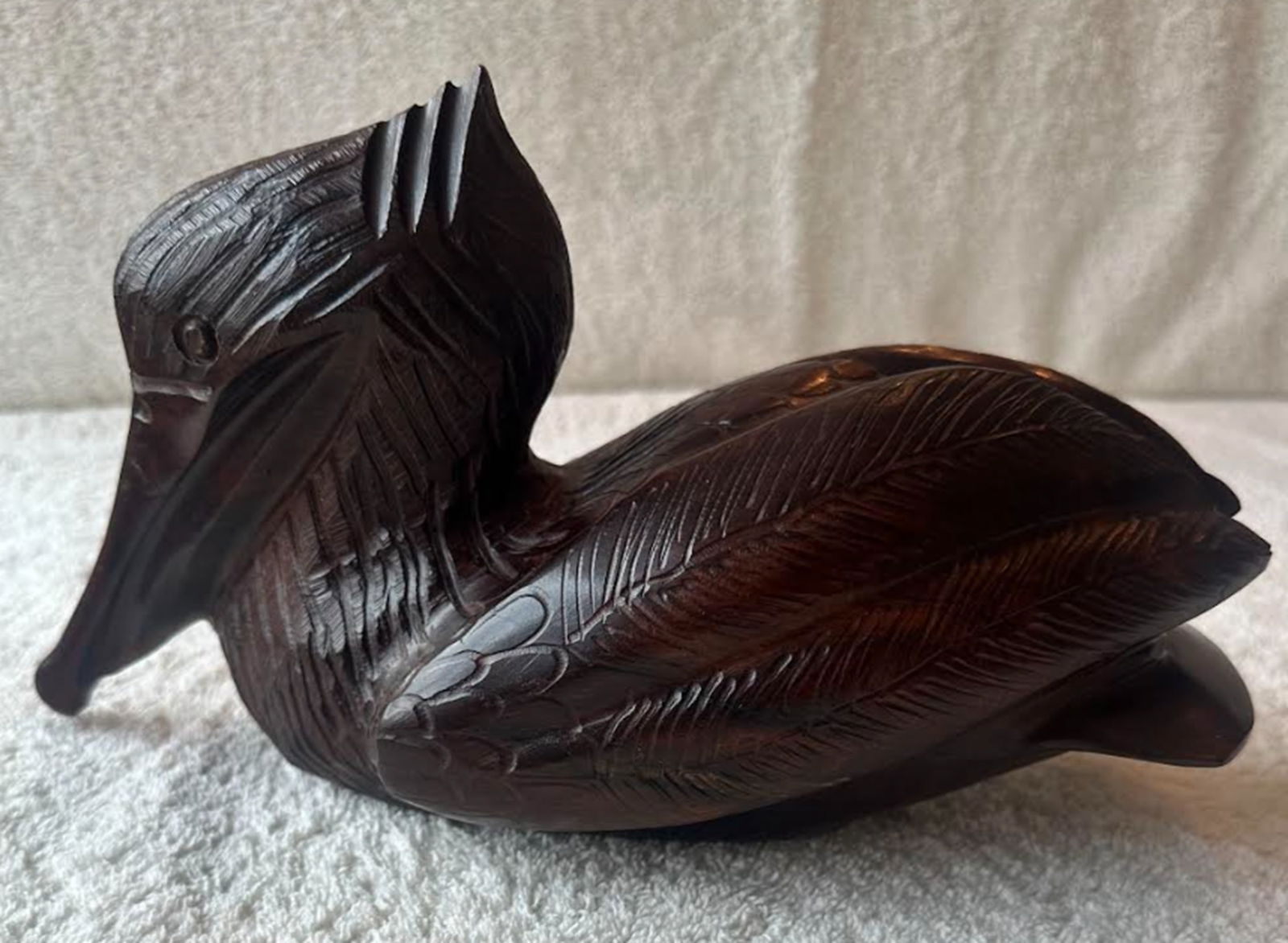 Hand Carved Ironwood Floating Pelican Figurine Statuette Circa 1981: This sculpture dating back to the mid ‘80’s presents the bird in repose defined by clear, detailed lines and balanced form. The very dense and heavy ironwood form dipicks a naturally dark, heavily