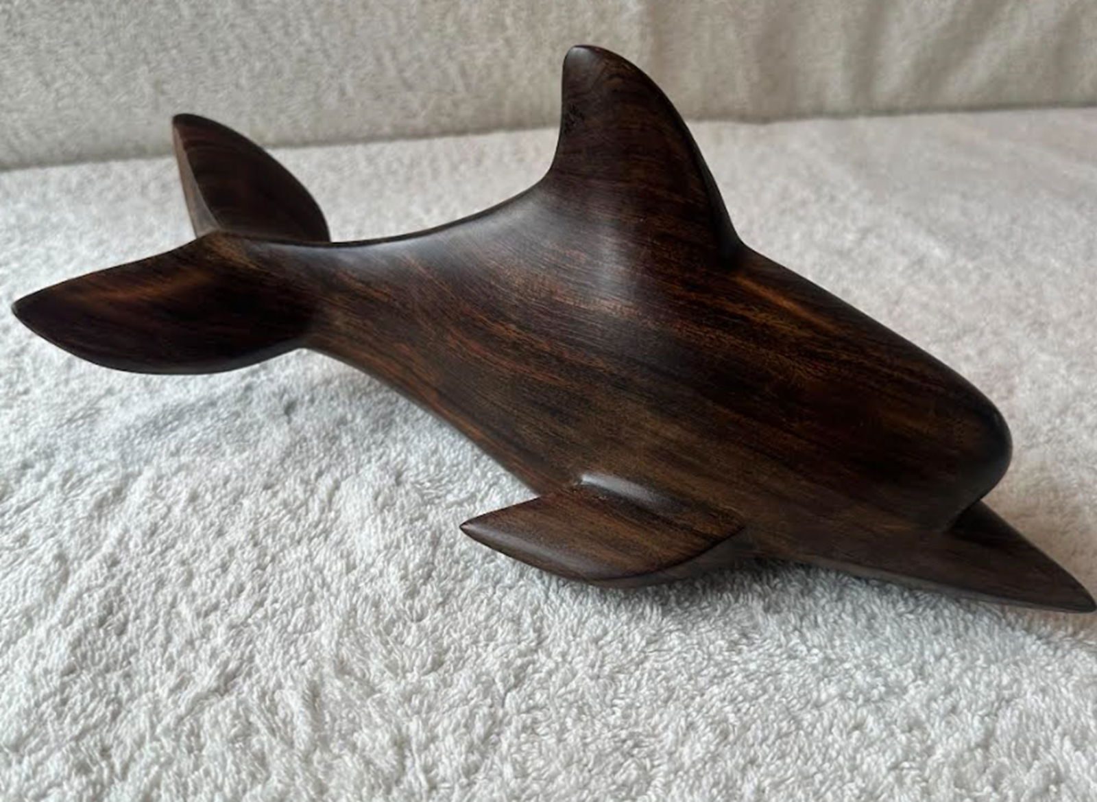 Hand Carved Ironwood Bottlenose Dolphin Figurine Statuette Circa 1986: Carved by a Seri artist named Jesus Martine, this sculpture depicts a bottlenose dolphins in a simple, swimming. Its strength lies in the deep, rich, chocolate-brown tones of the ironwood brought out