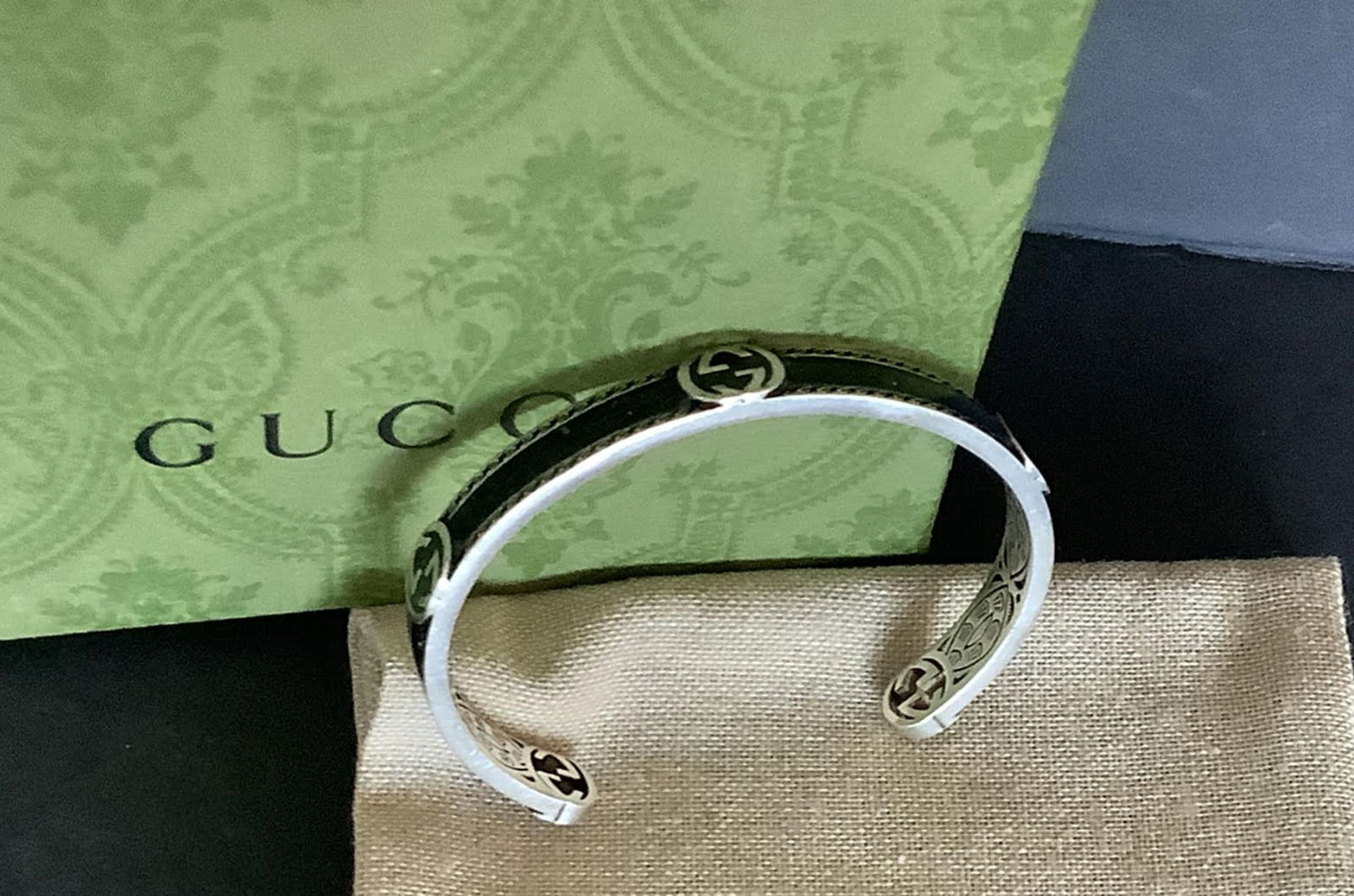 GUCCI Signed Sterling Silver Logo Cuff Bracelet Made in Italy: GUCCI Signed Sterling Silver Logo Cuff Bracelet Made in Italy Diameter, about 2.43" Gucci presents an elegant cuff bracelet crafted of sterling silver, featuring a refined logo that adds a touch of ic