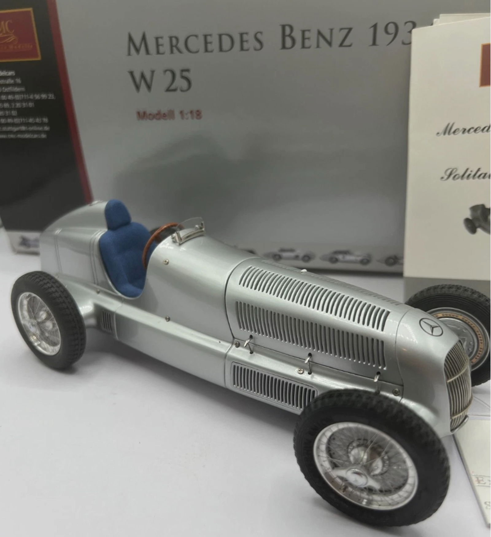 Mercedes-Benz W25 Classic Eifel Race 1934 Diecast Grand Prix Racing Car Vehicle. With Orig Box CMC: The CMC 1/18 Mercedes-Benz W25 Classic Eifel Race 1934 Diecast Grand Prix Racing Car is a highly detailed collectible toy vehicle representing the iconic Mercedes-Benz race car from 1934. This 1:18 sc