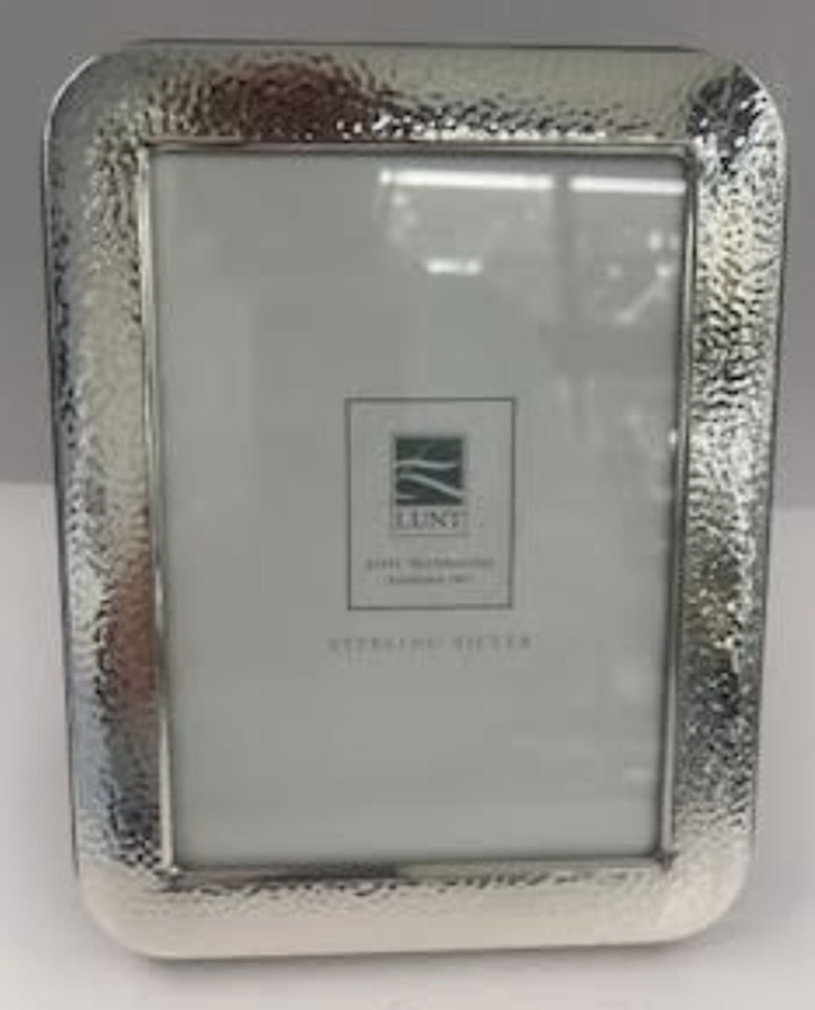 Lunt Sterling Silver Hammered Picture Frame: Lunt Sterling Silver Hammered Picture Frame. sterling silver picture frame by Lunt Silversmiths. It has a hammered finish and is lacquered so it won’t tarnish. The back is wood and it can be display