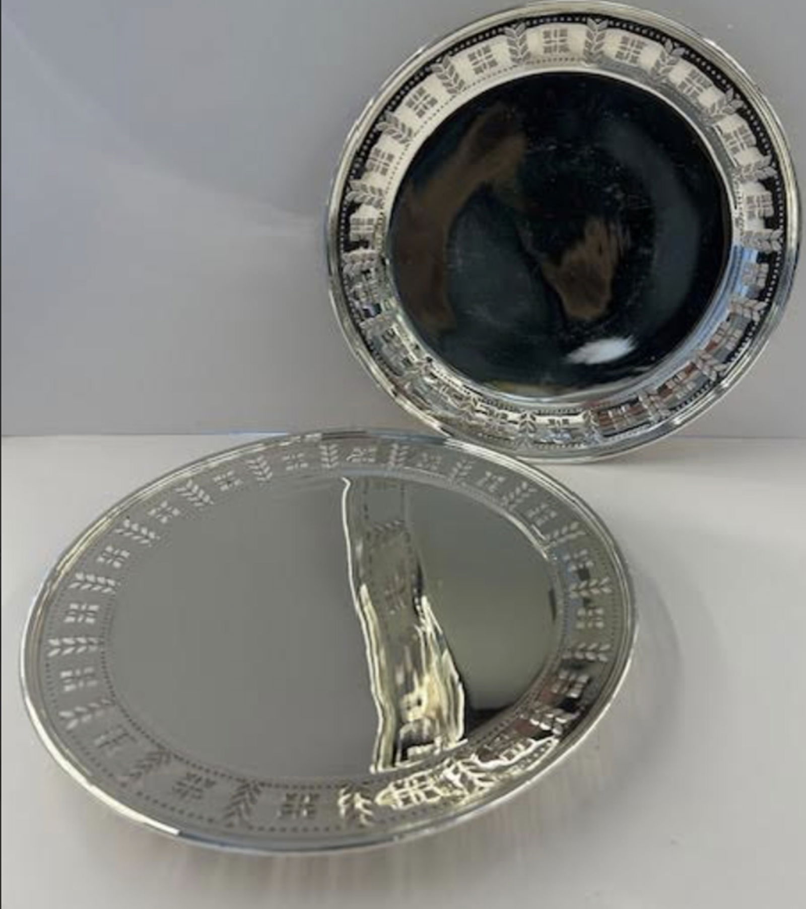 Tiffany & Co Sterling Silver Pair of Tazza Bowl Tray Platters: Tiffany & Co Sterling Silver Pair of Tazza Bowl Tray Platters A cutout Aztec pattern encircles the circumference and is sandwiched between a row of tiny cutout circles. Measures approx Height: 1 in