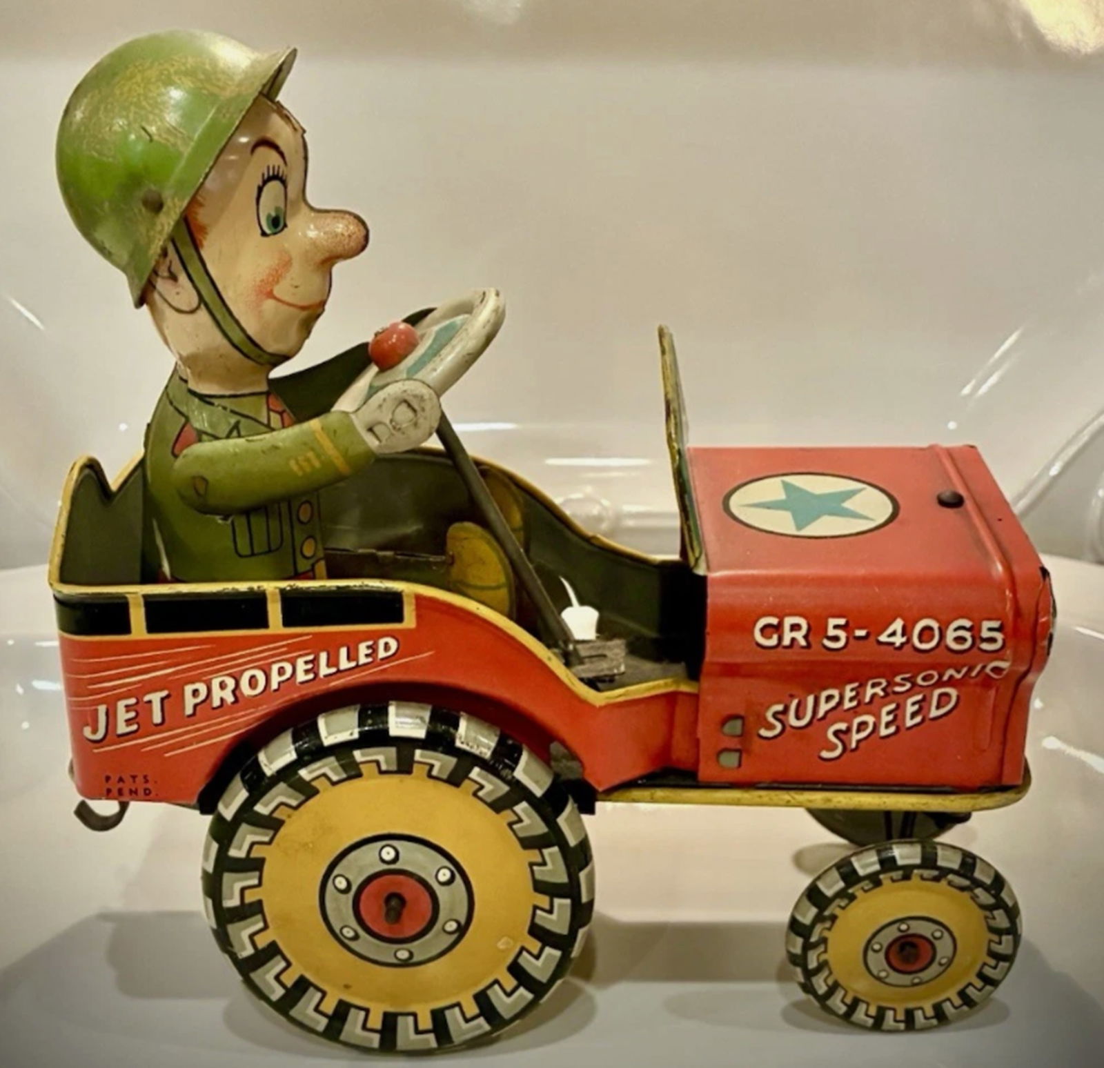 Tin Litho Windup GI Joe Bouncing Jeep 1940 Works!: Tin Litho Windup GI Joe Bouncing Jeep 1940 Works! 1940 GI Joe jouncing jeep tin wind-up toy, featuring the iconic character family of GI Joe. This unique art toy is a collectible item from the United