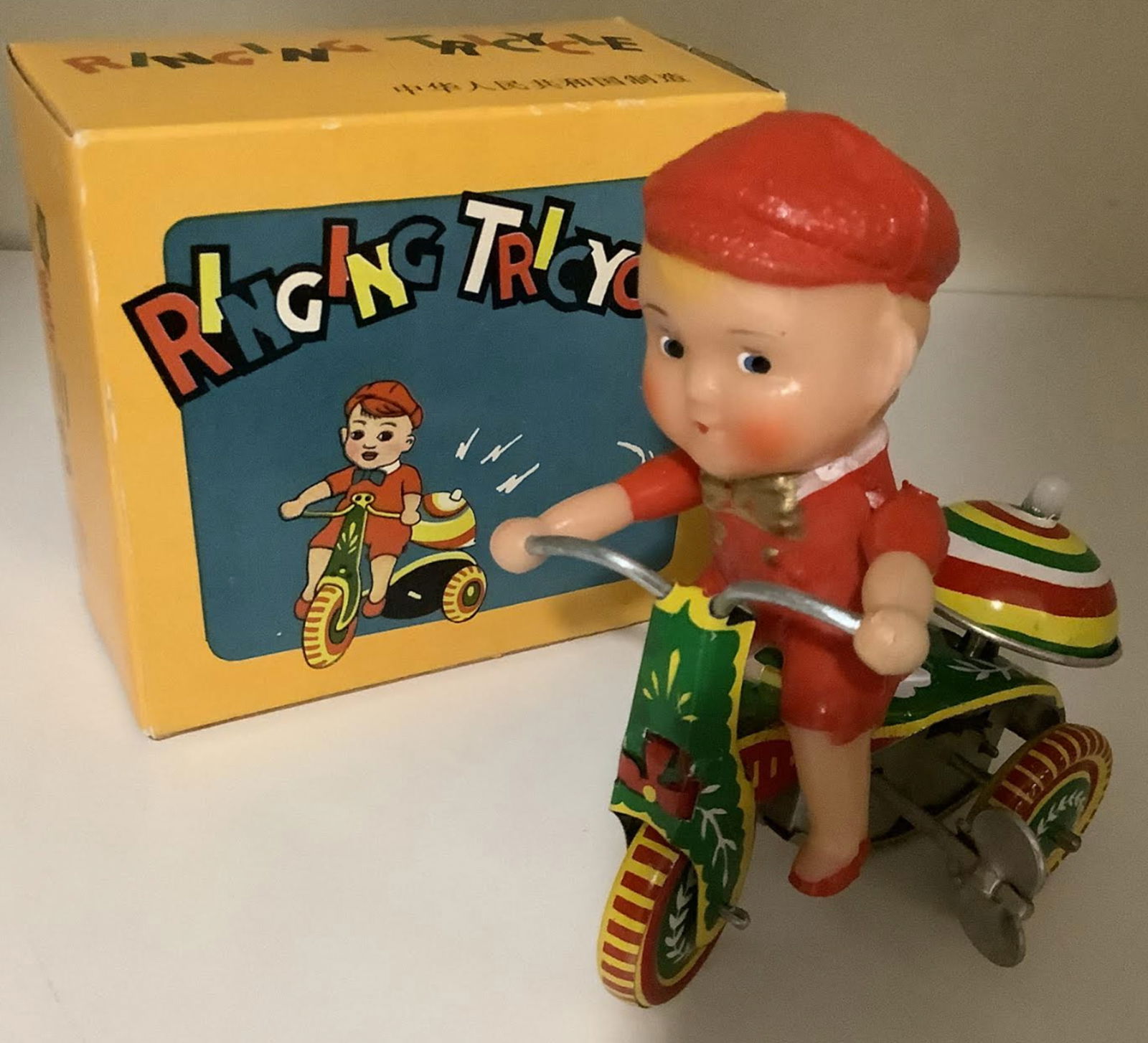 Tin Litho Windup Ringing Tricycle With key and Box: Tin Litho Windup Ringing Tricycle With key and Box. Measures approx 3.5 inches wideand 4.25 inches tall