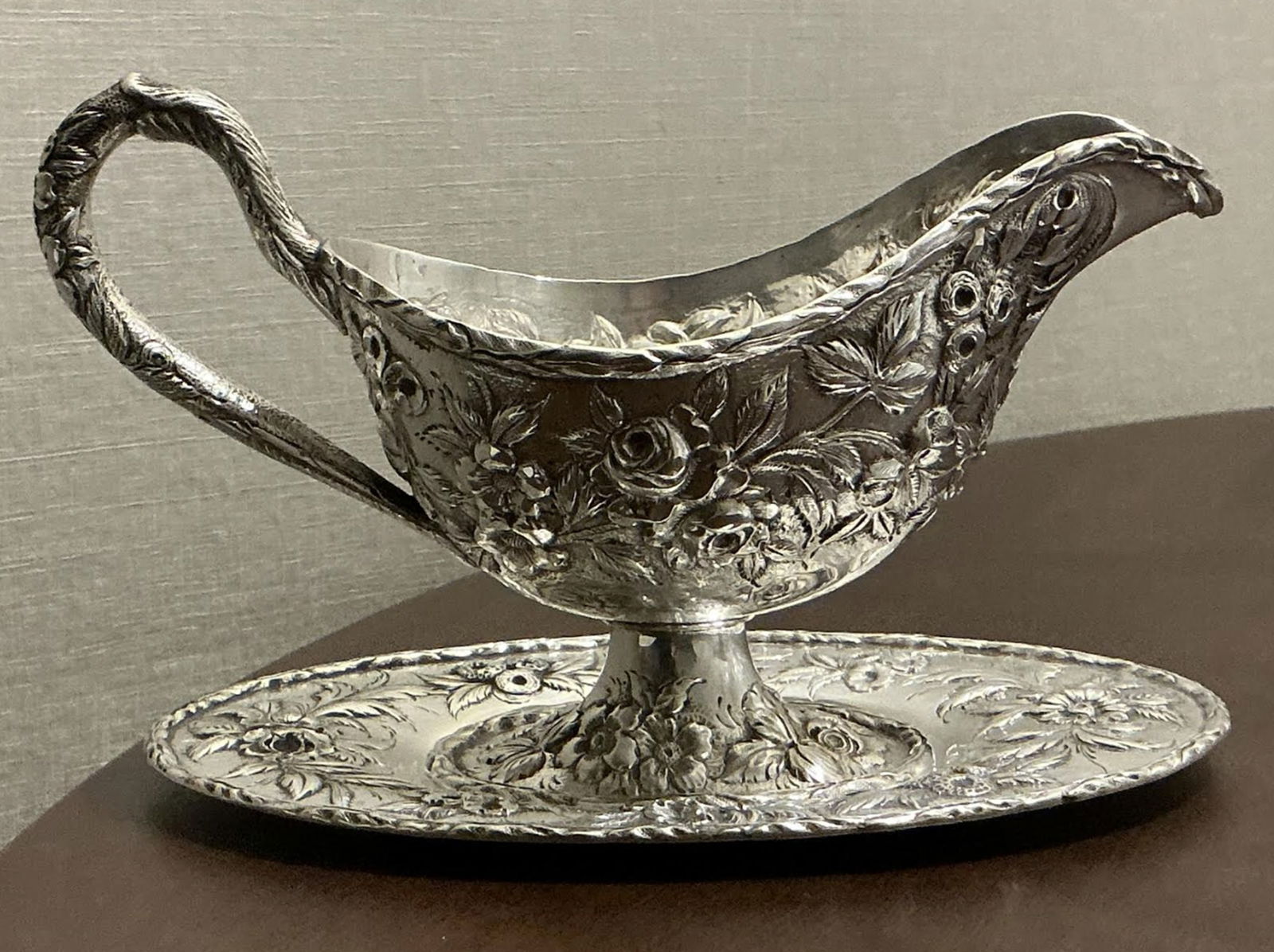 KIRK Sterling Silver REPOUSSE SAUCEBOAT & UNDERPLATE-#278-77: KIRK Sterling Silver REPOUSSE SAUCEBOAT & UNDERPLATE-#278-77. The sauceboat is 5 3/8 inches tall by 8 5/8 inches long, and the oval underplate is 8 ¼ inches long by 5 1/4 inches wide. 