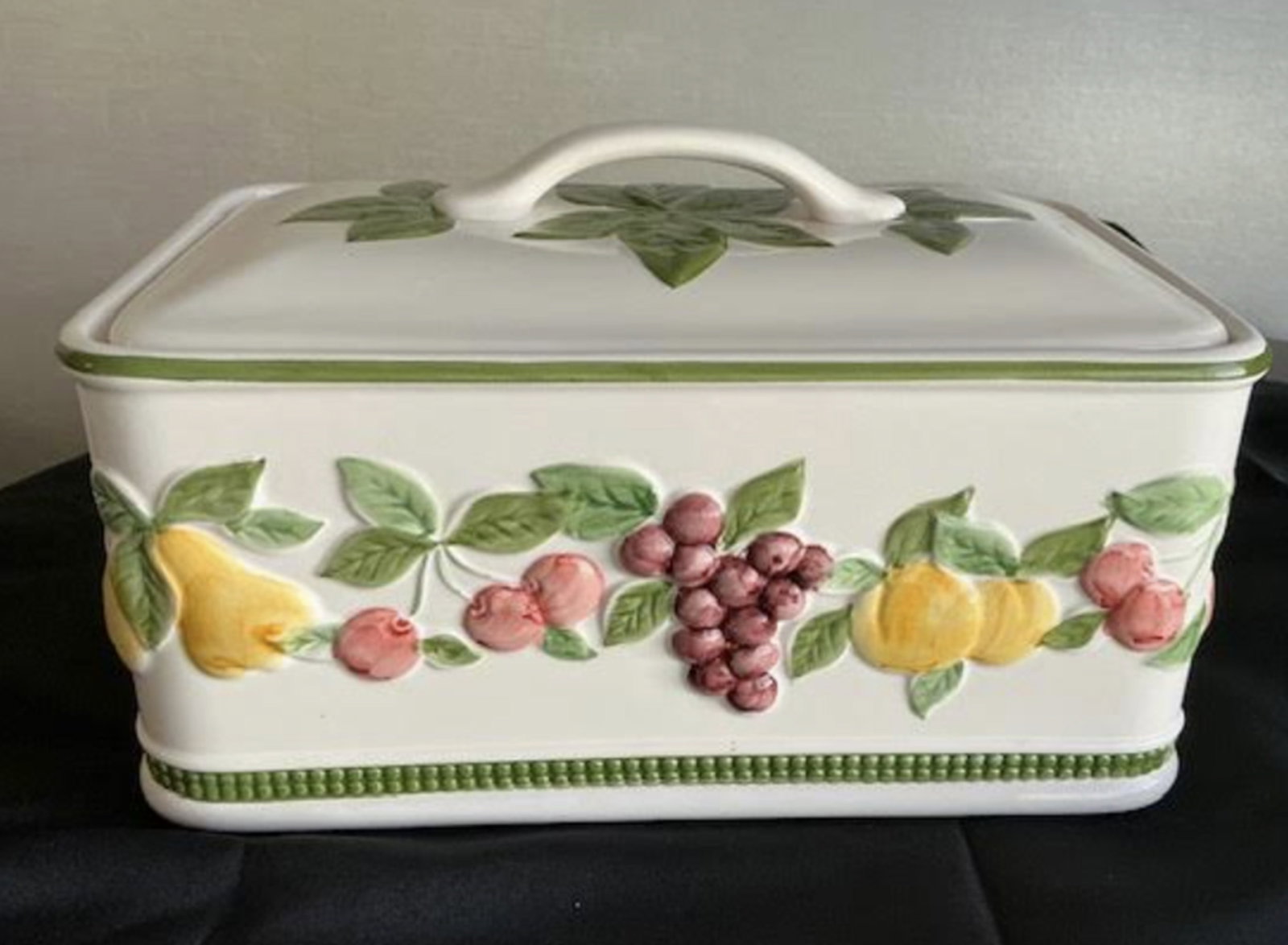 Porcelain Bread Box with Floral and Fruit Design: Porcelain Bread Box with Floral and Fruit Design. Measures approx 14 inches wide x 8.5 inches deep and 7 inches tall with lid handle. No chips or cracks