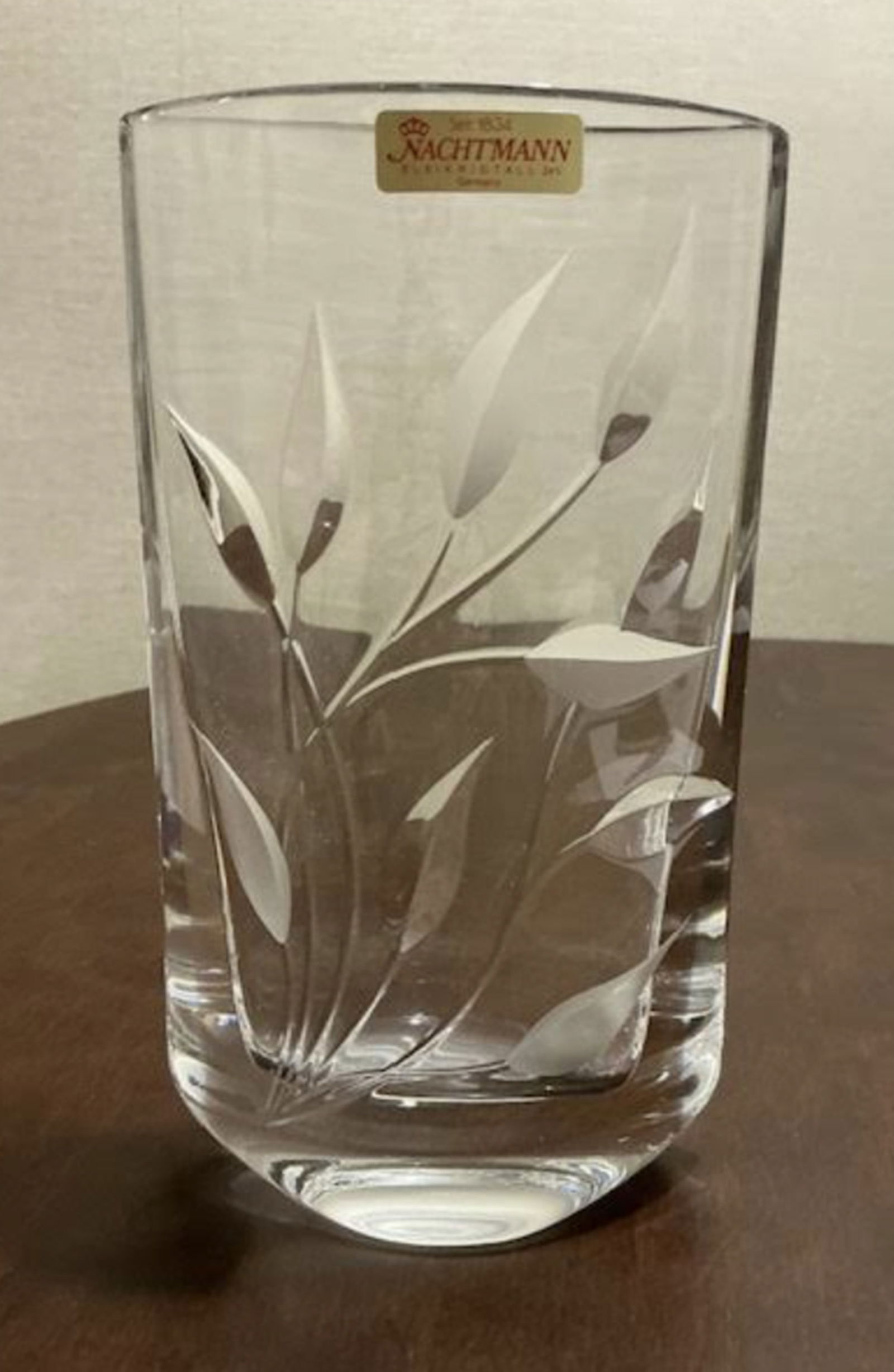 Nachtman Crystal floral designed vase with Sticker: Nachtman Crystal floral designed vase with Sticker. Measures approx 9 inches tall and 5 inches wide