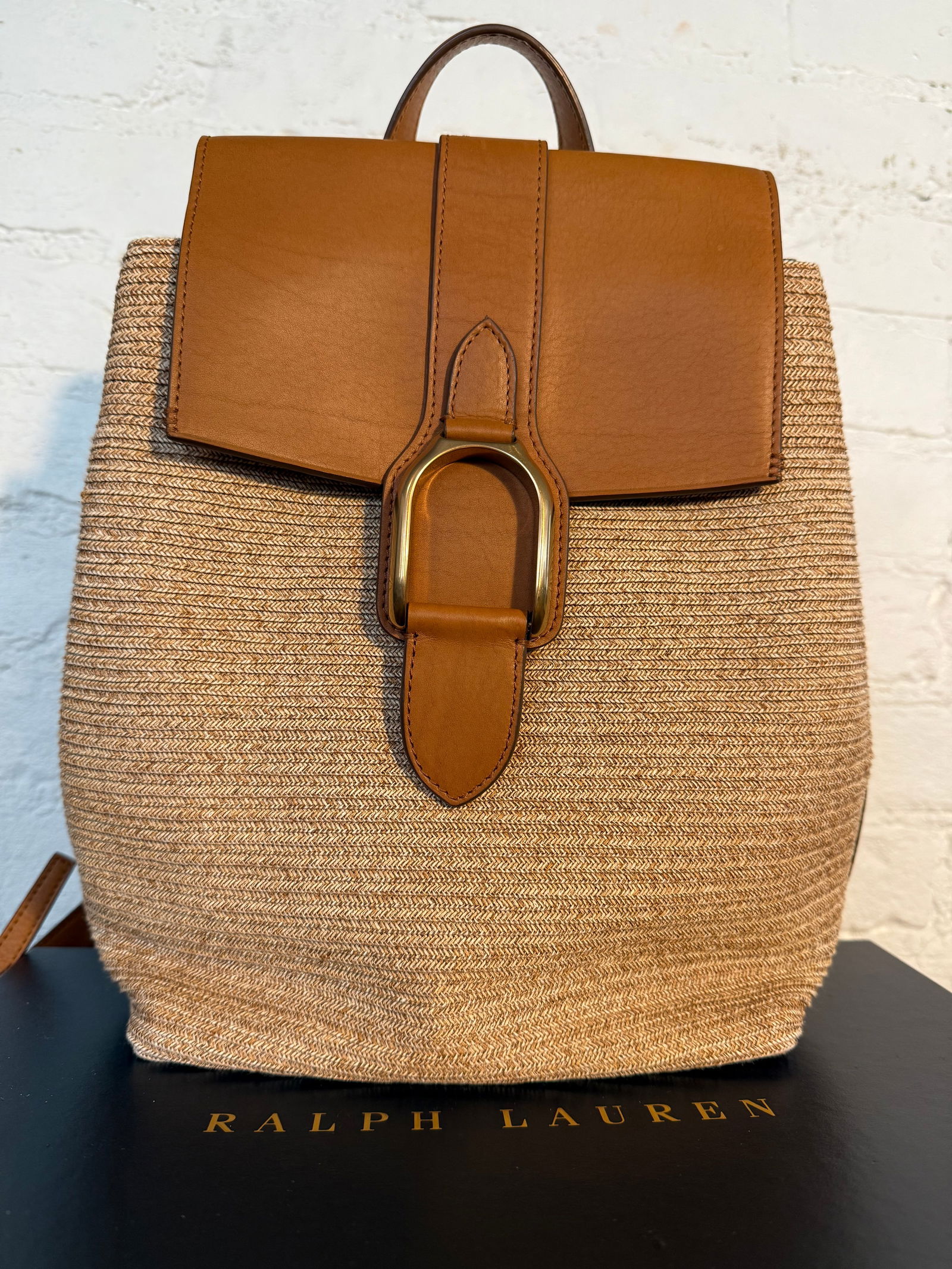 Collection Ralph Lauren Wellington Backpack: Collection Ralph Lauren Wellington Backpack Woven backpack with calfskin leather detailing and gold stirrup hardware. Used/ overall in great condition but has damaged leather inside the bag shown in p