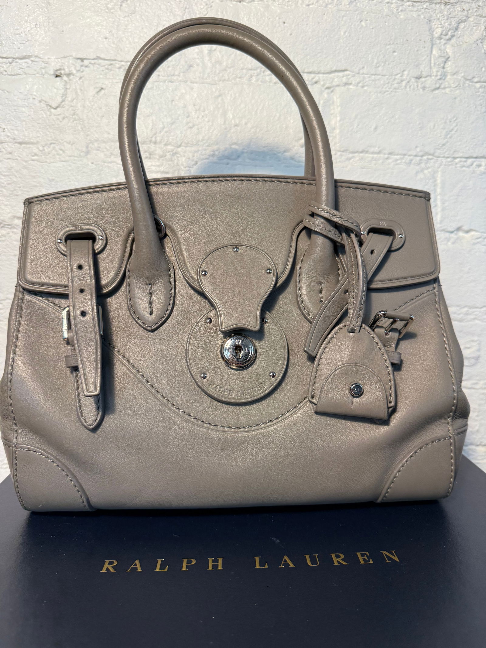 Ralph Lauren Collection Ricky 27 Handbag: Ralph Lauren Collection Ricky 27 Handbag Lightly used/like new. Removable crossbody strap & keybell. Lined in purple leather with interior card pocket. Lock closure option Grey calfskin leather Measur