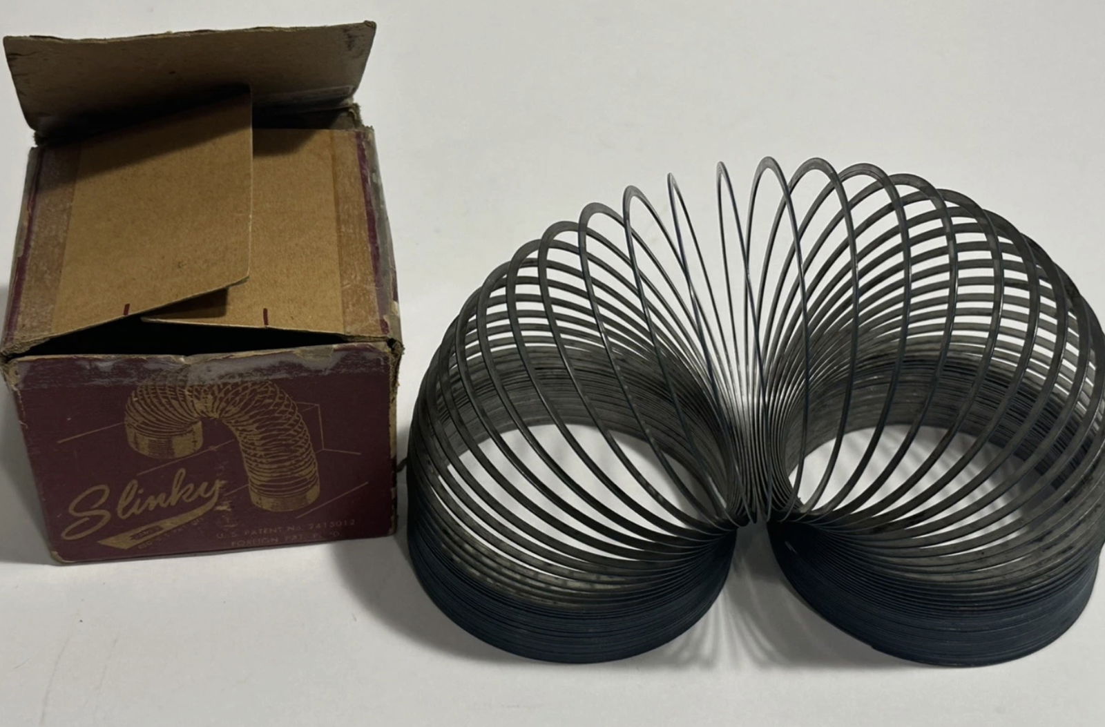 Original Slinky James Industries Walking Metal Toy Red w Original Box 1947: Original Slinky James Industries Walking Metal Toy Red w Original Box 1947. Original Slinky metal toy, manufactured by James Industries in the United States. This classic toy features a red color and