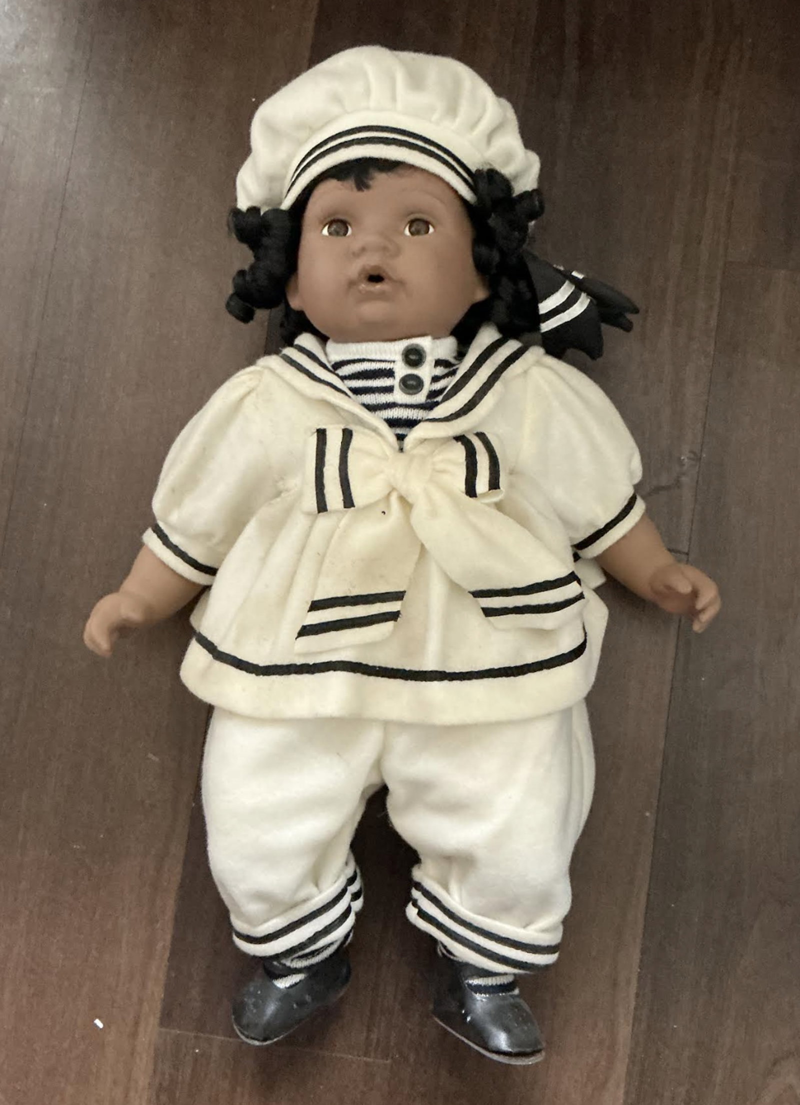 Cathay Collection Sailor Doll: Cathay Collection porcelain doll dressed in a sailor outfit. These collectible dolls often feature a soft-stuffed body with porcelain heads, hands, and legs Measures approx 22 inches Tall