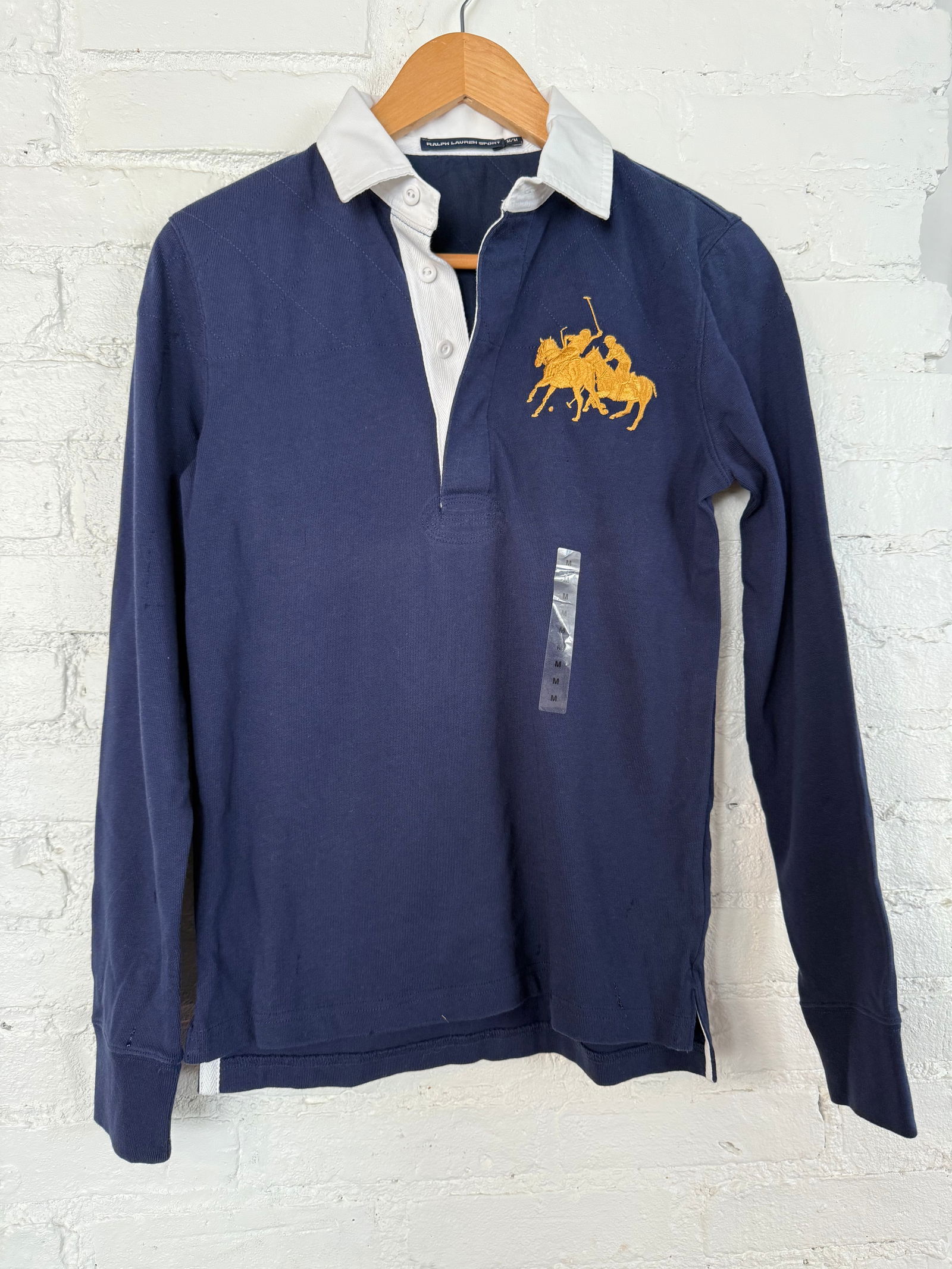 Women's Polo Ralph Lauren Navy Rugy Polo: Gold double pony player logo, extra button included, quilted shoulders, new never worn. Size Medium. Navy Measures approx Shoulder front to hem 25 inches Shoulder back to hem 23.5 inches across front