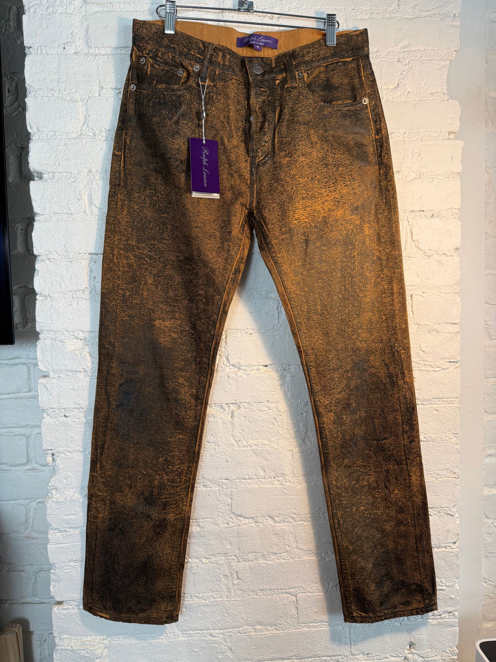 Ralph Lauren Collection Coated Denim: Lightweight denim with distressed coating. New with tags. MSRP$ 1190. Size 28 Brown with black coating Measures approx out seam 39.5 inches inseam 28.5 inches Across waist 15.5 inches