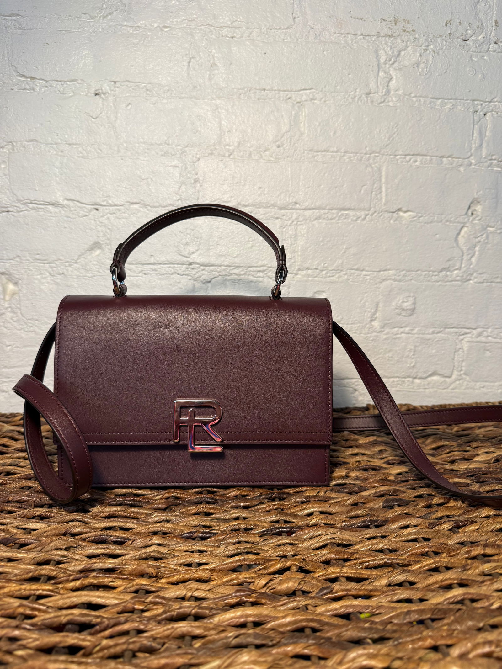 Ralph Lauren Collection Stacked RL Top Handle Bag: Like new includes detachable crossbody strap. Lined in cognac leather. Snap closure. Silver hardware Burgundy calfskin leather Measures approx 8.5"X6.6"X3.25" HANDLE DROP:3"