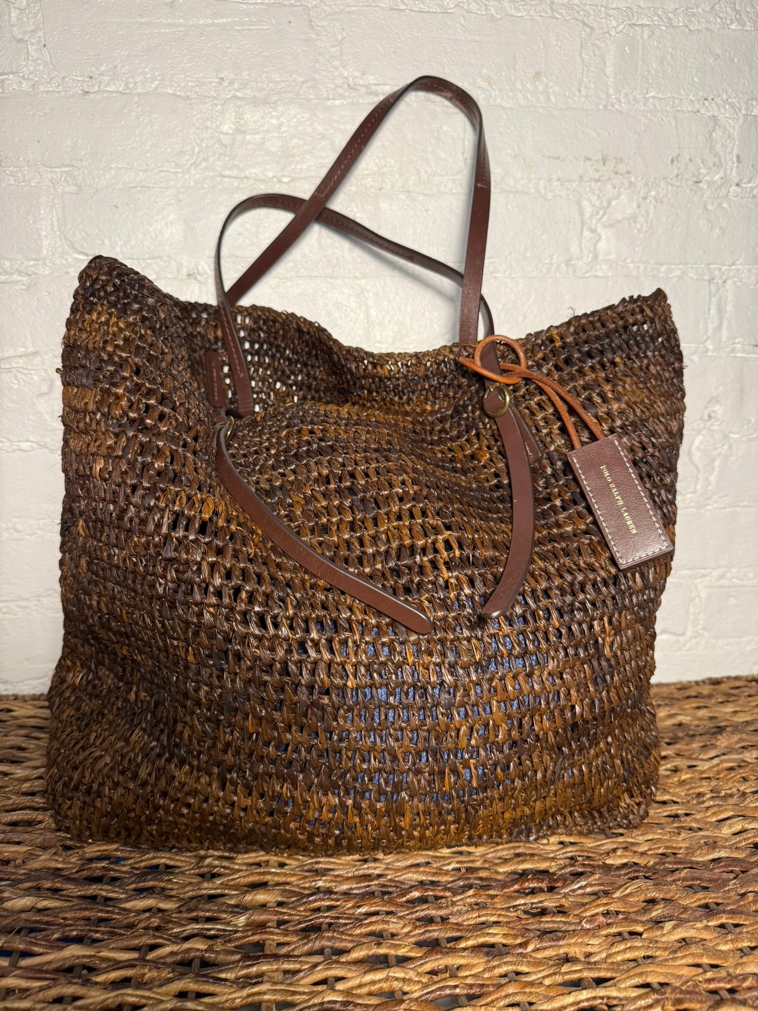 Polo Ralph Lauren Tote Bag: Lightweight dark brown raffia bag with leather straps. Lightly used with little to no signs of use.