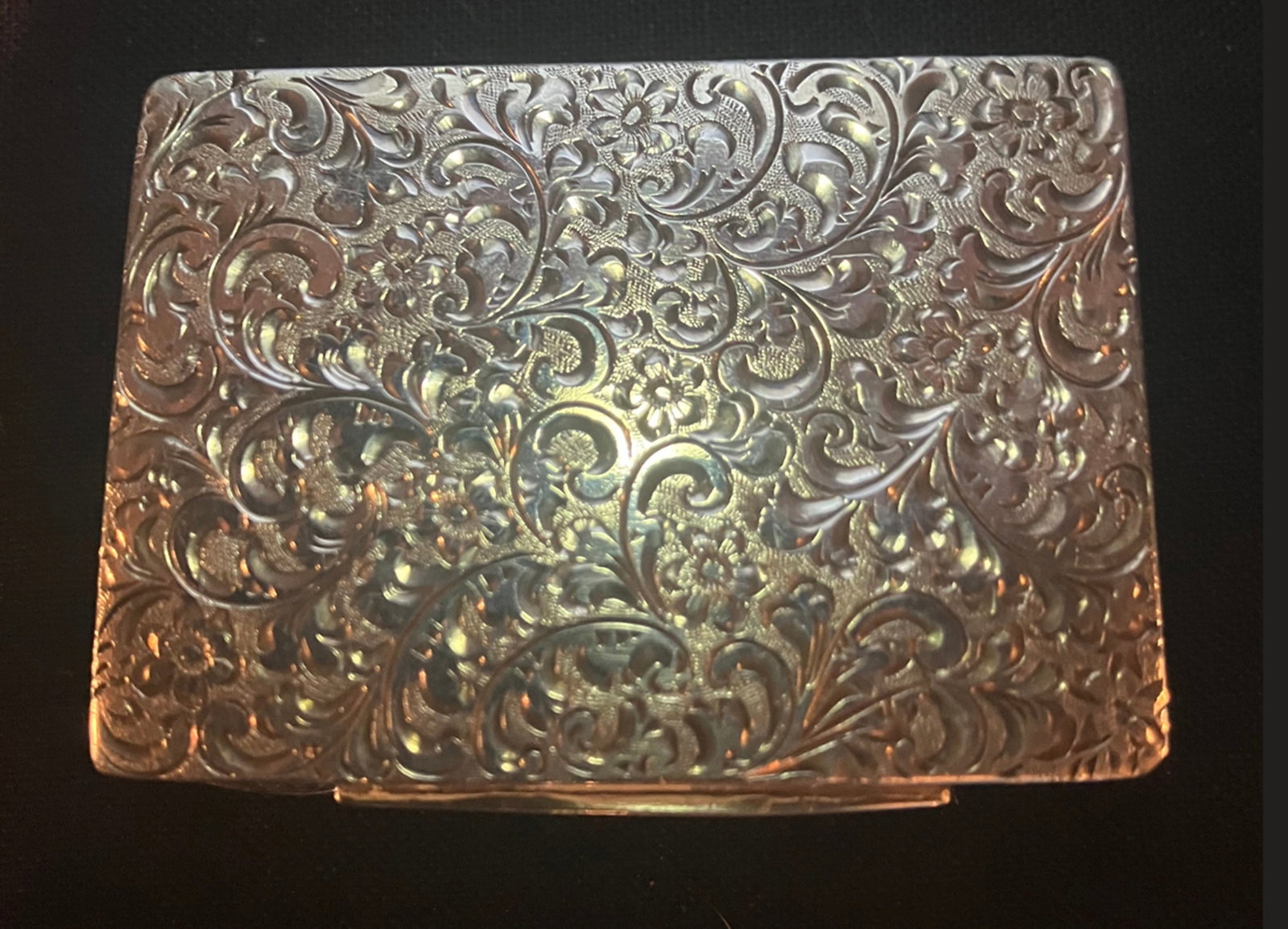 Austria Sterling Silver Pill Box: Austria. Austria Sterling Silver pill or small box. Elaborate bright cut on top and sides with bottom having straight deep cut lines. Gilded interior. Bottom has two partly circular indents. measures 