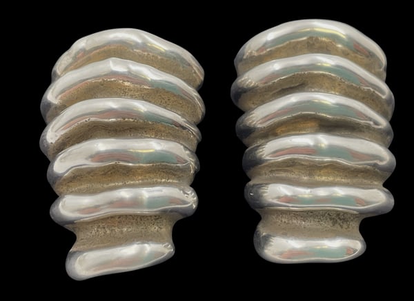 Pair of Sterling Silver Earrings in Mid-Century Modern Style: Pair of sterling silver earrings in Mid-Century Modern style, with an elegant, geometric design. They measure 1 1/2'' in length by 1'' in width and bear hallmarks as shown.