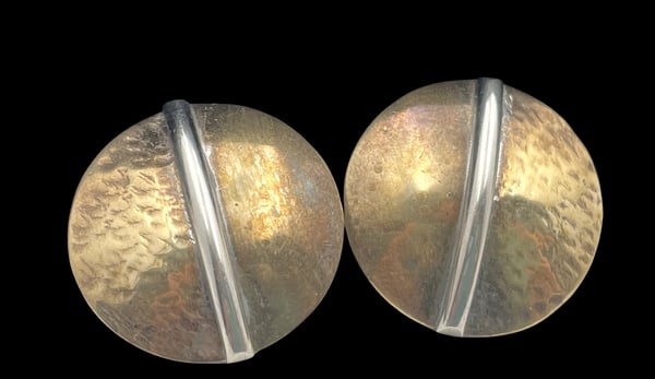 Pair of Sterling Silver and Brass Earrings in Mid-Century Modern Style: Pair of sterling silver and brass earrings in Mid-Century Modern style with an elegant, geometric design. They measure 1'' in diameter.