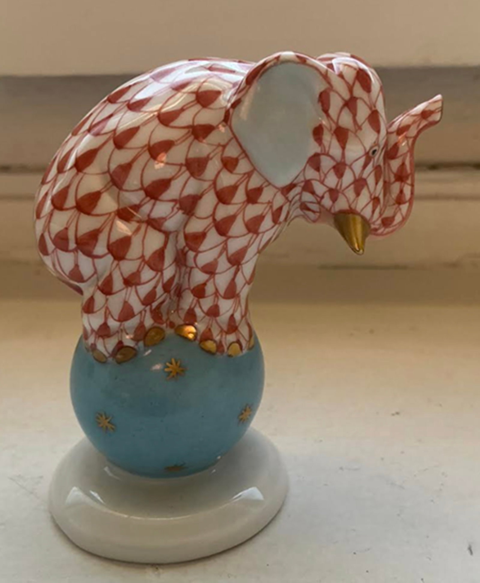 Herend Signed Porcelain Rust Fishnet Elephant on Ball Figurine with 24k gold Accents Made in: Herend Signed Porcelain Rust Fishnet Elephant on Ball Figurine with 24k gold Accents Made in Hungary. Measures approx 2.25 inches wide and 2 3/4 inches tall. no chips or cracks present