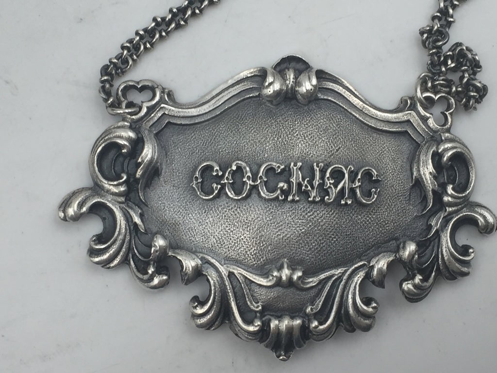 Buccellati Italian Sterling Silver Cognac Ornate Claret Bar Jug Label: Rare Buccellati sterling silver claret bar jug label. COGNAC embossed on the front in the center.Marks on the back: Gianmaria Buccellati (signature and Italian maker's mark), ITALY, 925 (encircled sil