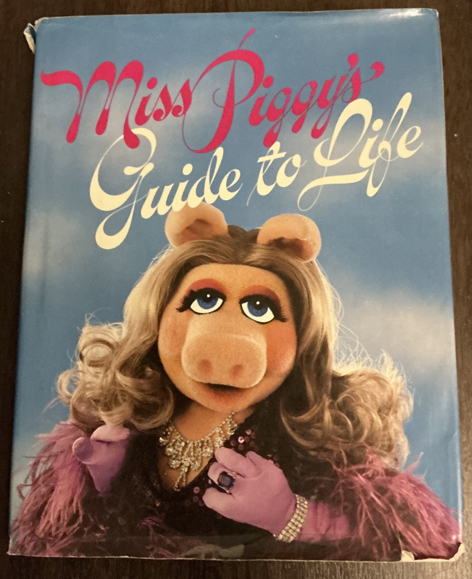 Miss Piggy’s Guide to Life Hard Cover Book 1971: Miss Piggy’s Guide to Life Hard Cover Book 1971 perfectly captures the glamorous excess, wit, and comedic confidence that made Miss Piggy one of the most beloved characters from Jim Henson’s Muppe
