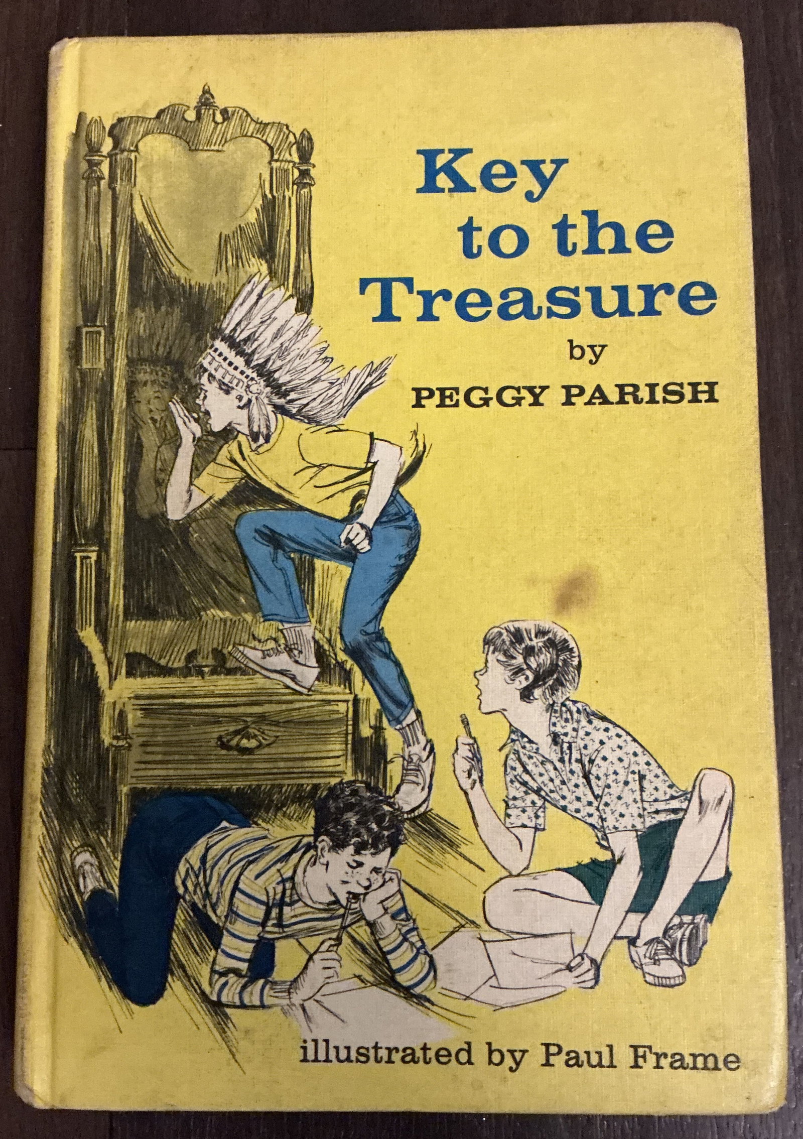 Key to the Treasure Hard Cover Book By Peggy Parish, Paul Frame 1966: Key to the Treasure Hard Cover Book By Peggy Parish, Paul Frame 1966 captures the golden age of mid-century children’s mystery and adventure literature. The dramatic yellow pictorial cover features 