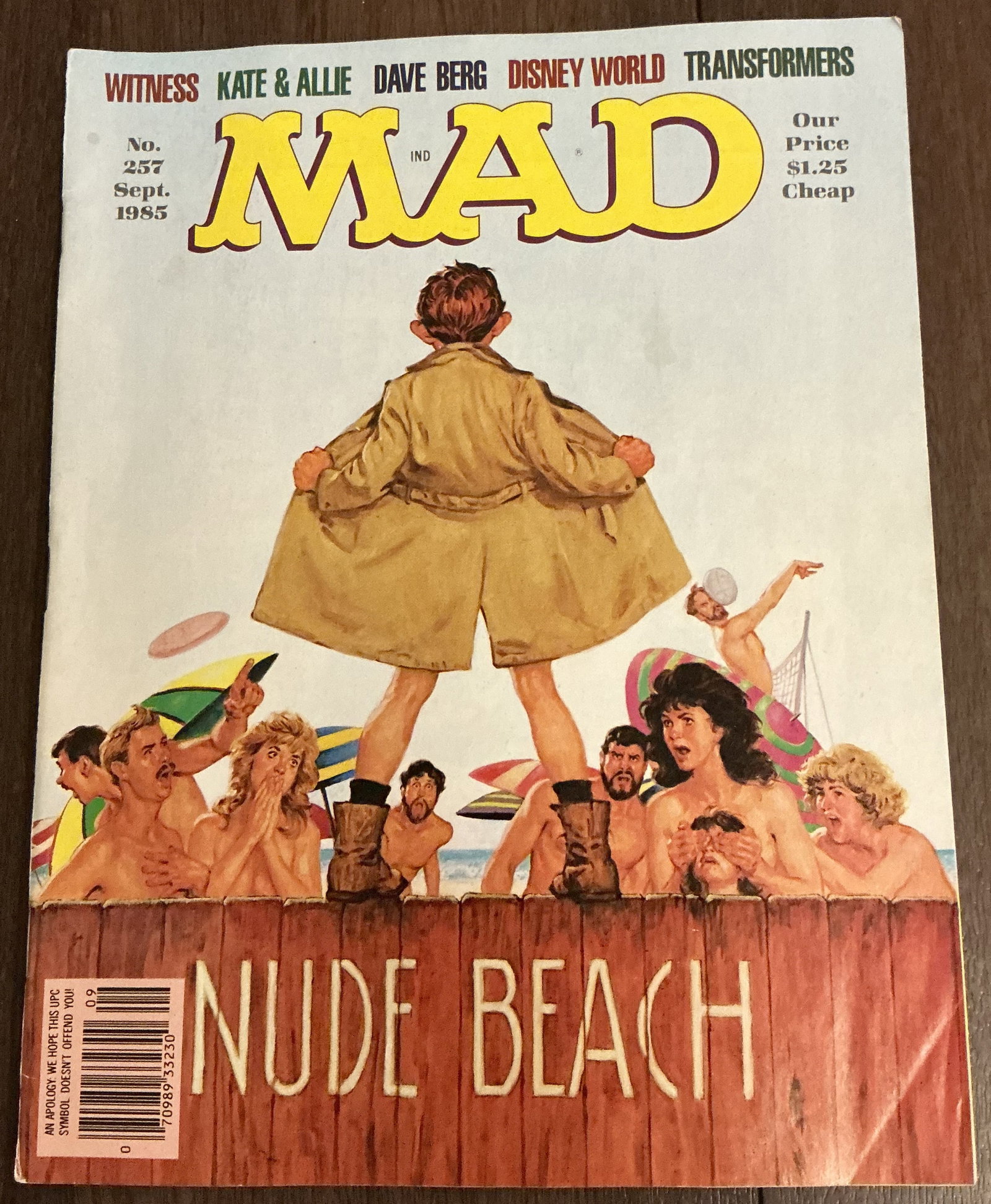 MAD Magazine Nude Beach No. 257 September 1985: MAD Magazine Nude Beach No. 257 September 1985 featuring the memorable “Nude Beach” cover artwork in classic satirical MAD style. This issue includes parodies and humor pieces referencing 1980